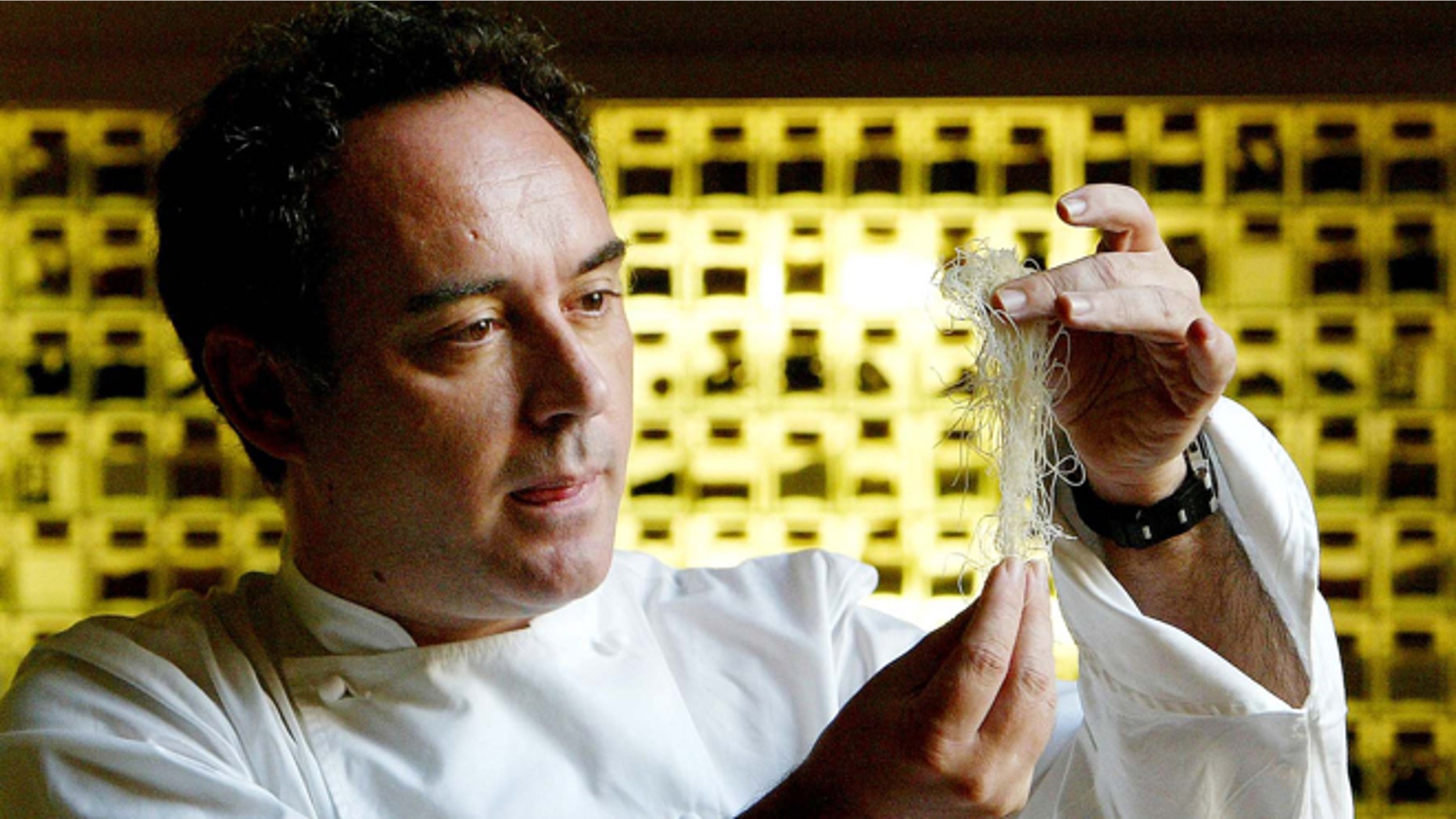 FILE - In this Dec. 5, 2003 file photo, Spanish chef Ferran Adria examines ingredients in his kitchen workshop in Barcelona, Spain. Spainâs famed chef Ferran Adria says the wine cellar of his former restaurant, elBulli is to be auctioned to raise funds for his new project, the elBulli Foundation. (AP Photo/Bernat Armangue, File)