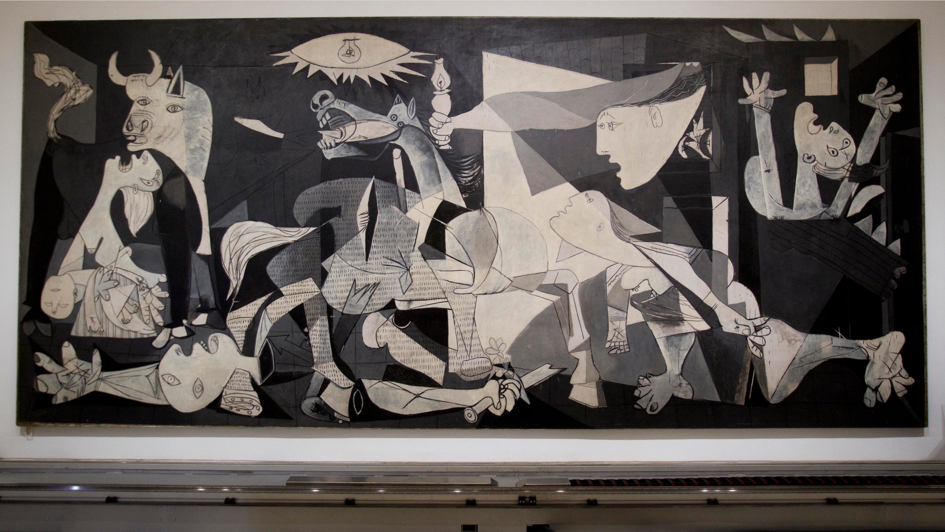 This Tuesday Feb. 21, 2012 photo of Pablo Picasso's "Guernica" painting is seen displayed at the Reina Sofia Museum in Madrid. (AP Photo/Paul White)