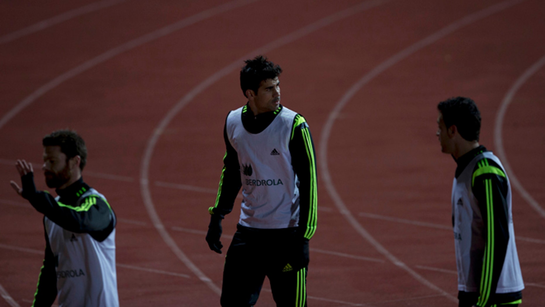 Diego Costa, center, leaves his first training session with Spain in Madrid, Monday March 3, 2014. Spain will play Italy Wednesday in a friendly soccer match. (AP Photo/Paul White)