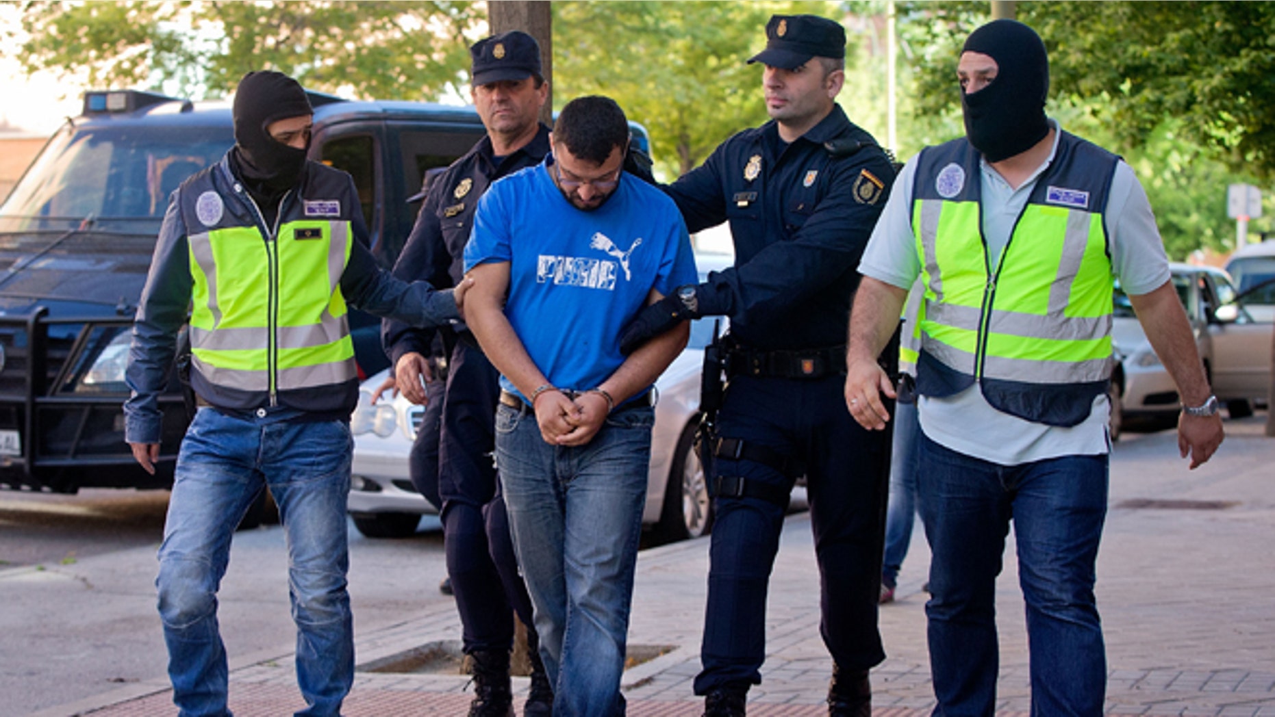 Police arrest a man suspected of belonging to a Jihadist recruiting network on June 16, 2014 in Madrid, Spain.