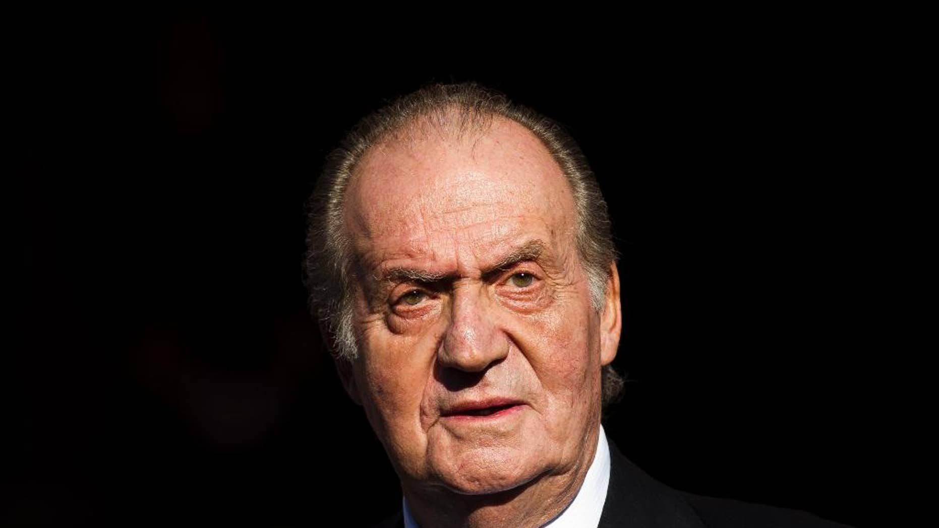 FILE - In this Tuesday, Dec. 27, 2011, file photo, Spain's King Juan Carlos leaves after the official opening of the Parliament, in Madrid. Carlos plans to abdicate and pave the way for his son, Crown Prince Felipe, to take over, Prime Minister Mariano Rajoy told the country Monday, June 2, 2014, in an announcement that was broadcast nationwide. The 76-year-old Carlos oversaw Spain's transition from dictatorship to democracy but has had health problems in recent years. (AP Photo/Daniel Ochoa de Olza, File)