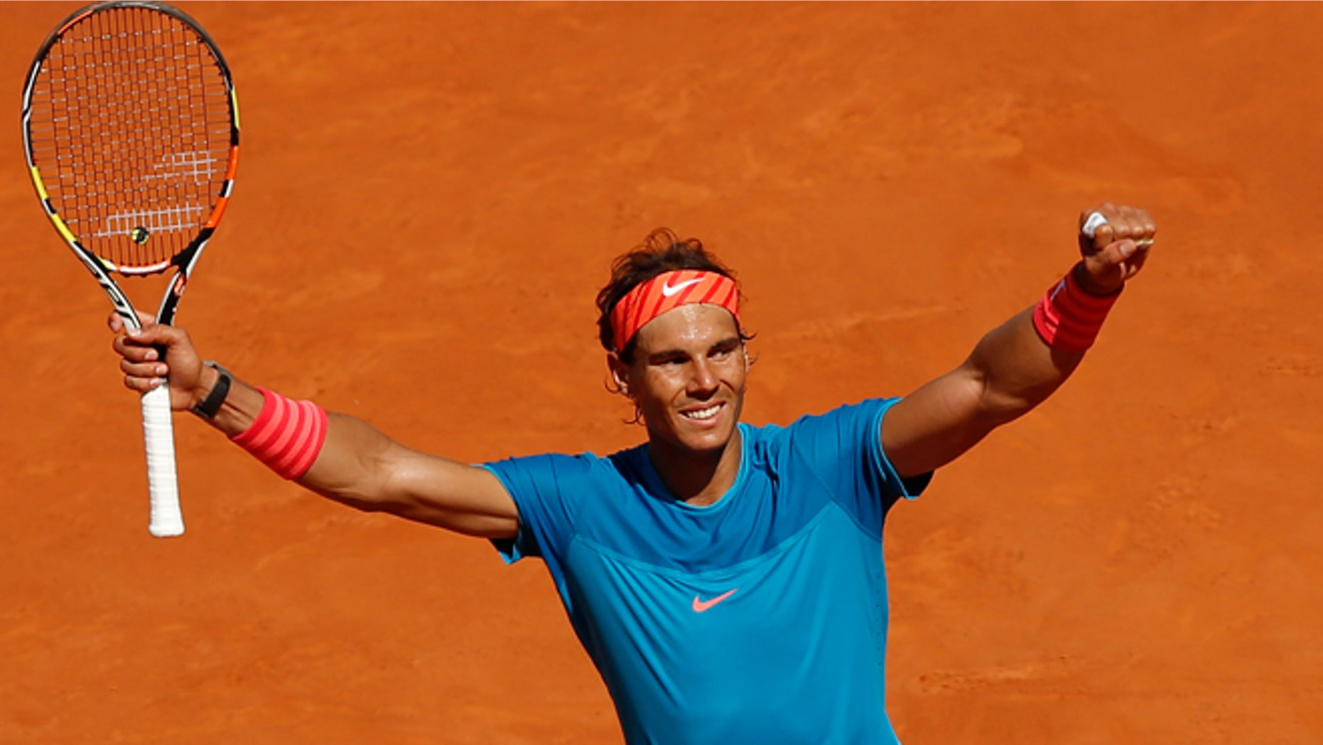 Rafael Nadal of Spain celebrates after winning his semifinal of the Madrid Open Tennis tournament in Madrid, Spain, Saturday, May 9, 2015. Nadal defeated Tomas Berdych of the Czech Republic 7/6, 6/1. (AP Photo/Daniel Ochoa de Olza)