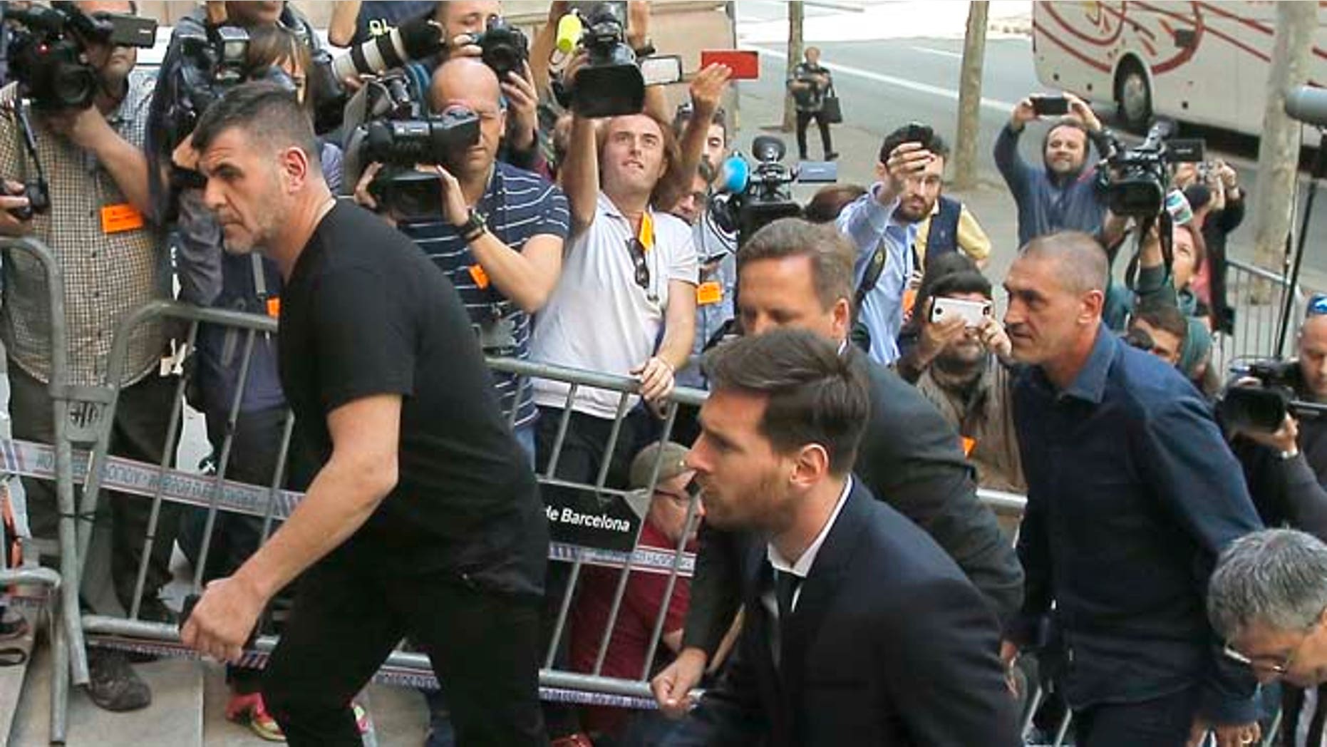 Barcelona soccer player Lionel Messi, center, arrives at a court in Barcelona, Spain, Thursday, June 2, 2016. Messi's tax trial began Tuesday. Messi and his father, Jorge Horacio, have been charged with three counts of tax fraud. They could be sentenced to nearly two years in prison if found guilty of defrauding Spain's tax authority of 4.1 million euros ($4.5 million) from 2007-09. (AP Photo/Manu Fernandez)
