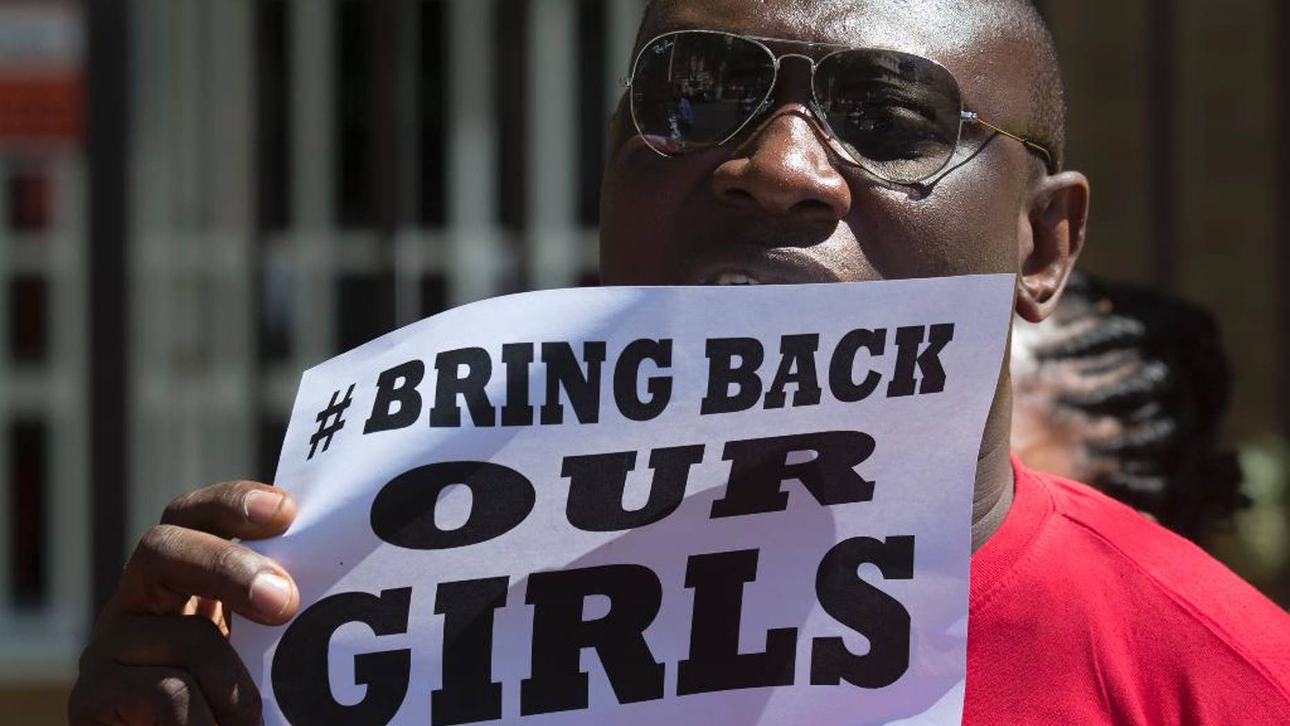 A Nigerian, resident in Spain protests outside the Nigerian embassy in Madrid, Spain, Friday, May 16, 2014 in support of the kidnapped school girls in Abuja, Nigeria. Boko Haram insurgents on April 15 abducted more than 300 students from the Chibok Government Girls Secondary School. Police say 53 managed to escape and 276 remain in captivity. (AP Photo/Paul White)
