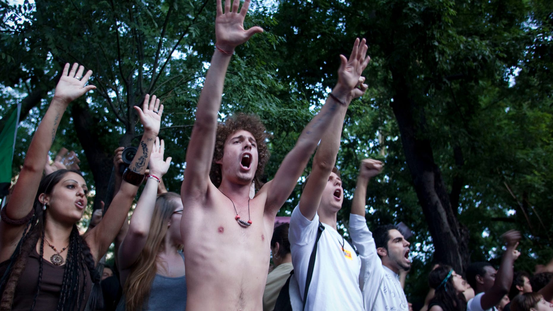 People shout slogans against the banks and the government in front of Interior Ministry building during a demostration Plaza de Sol, central Madrid Friday, Aug. 5, 2011. Police have prevented hundreds of anti-austerity protesters from entering the central plaza where they have held numerous demonstrations since May, railing against the political status quo.