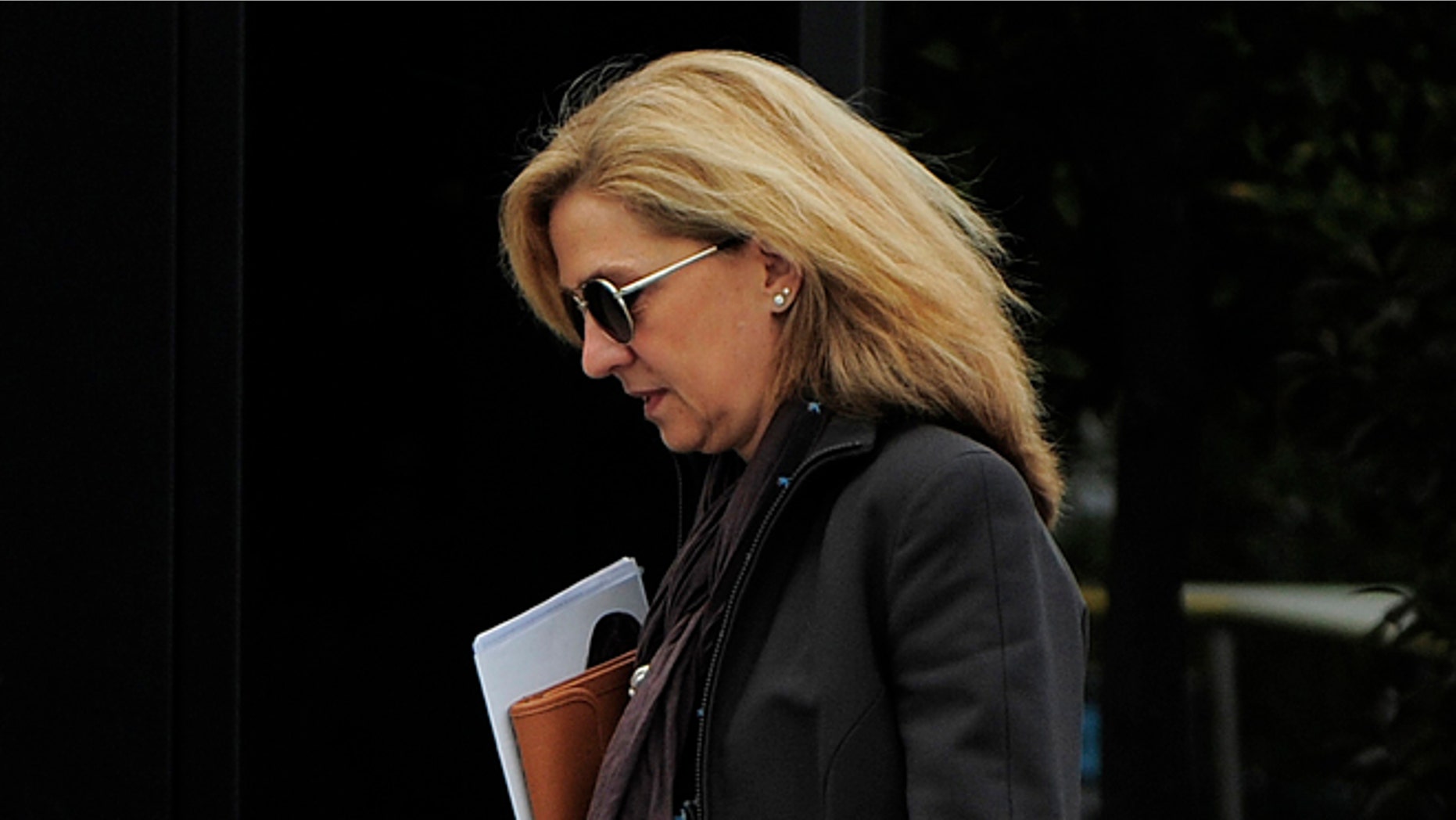 FILE - In this April 5, 2013 file photo, Spain's Princess Cristina walks toward her office in Barcelona, Spain. Spains King Felipe VI has removed the title Duchess of Palma de Mallorca from his sister Cristina in the latest move to distance the royal family from the princess as she awaits trial for tax fraud. The measure, signed by Felipe on June 11, 2015 was made law on being published in the Official State Gazette on Friday, June 12, 2015. (AP Photo/Manu Fernandez, File)