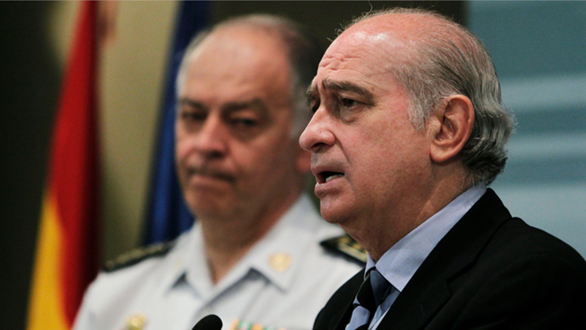 Spain's Interior Minister Jorge Fernandez Diaz, right, speaks during a news conference in Madrid, Saturday, June 22, 2013. Spanish police say they have arrested eight people suspected of recruiting jihadist militants for al-Qaida linked groups in Syria. The Spanish Interior Ministry said the arrests were made early Friday in the Spanish enclave of Ceuta, which is located on the northwest African coast, surrounded by Morocco on one side and the Mediterranean Sea on the other. (AP Photo/Andres Kudacki)