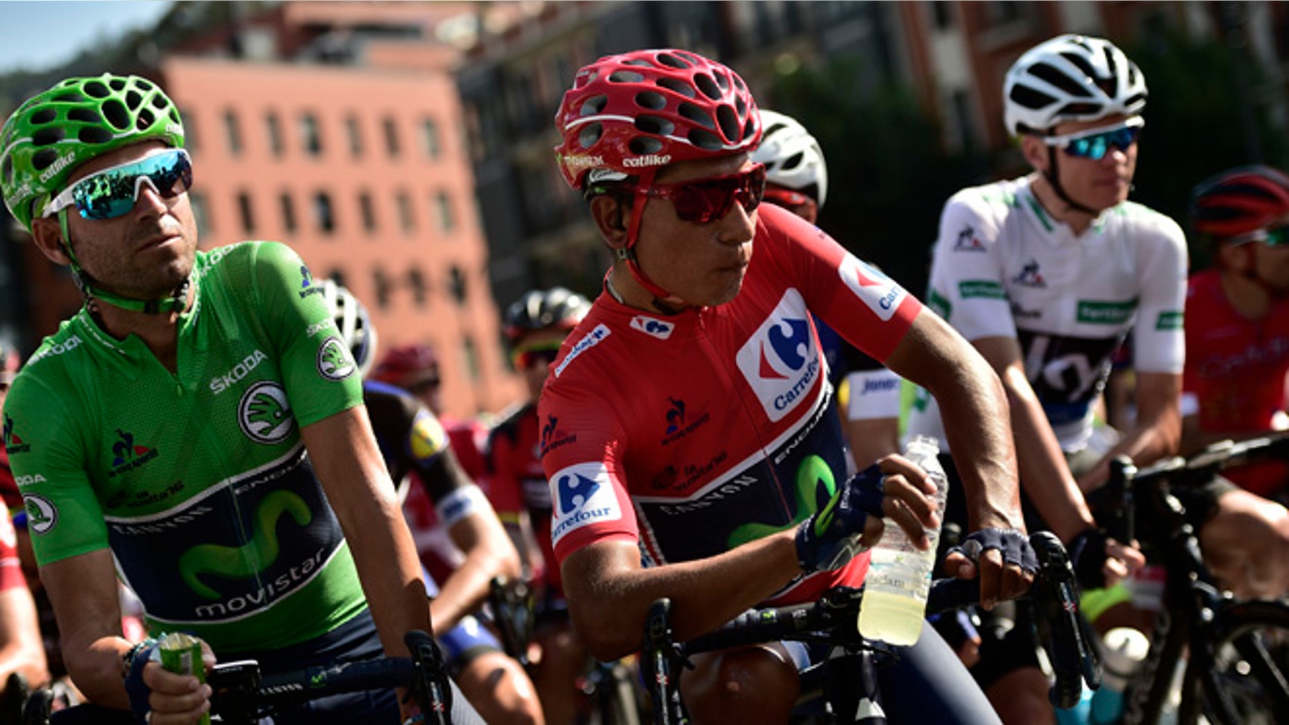 Sky's Team Christopher Froome of Britain, right, waits beside shirt race leader, Movistar's Team Nairo Quintana of Colombia, center, and team mate Alejandro Valverde of Spain, before the start of the 13th stage between Bilbao and Urdax Dantxarinea, 213,4 kilometers (132,6 miles), of the Spanish Vuelta cycling race that finish in Bilbao, northern Spain, Friday, Sept. 2, 2016. (AP Photo/Alvaro Barrientos)