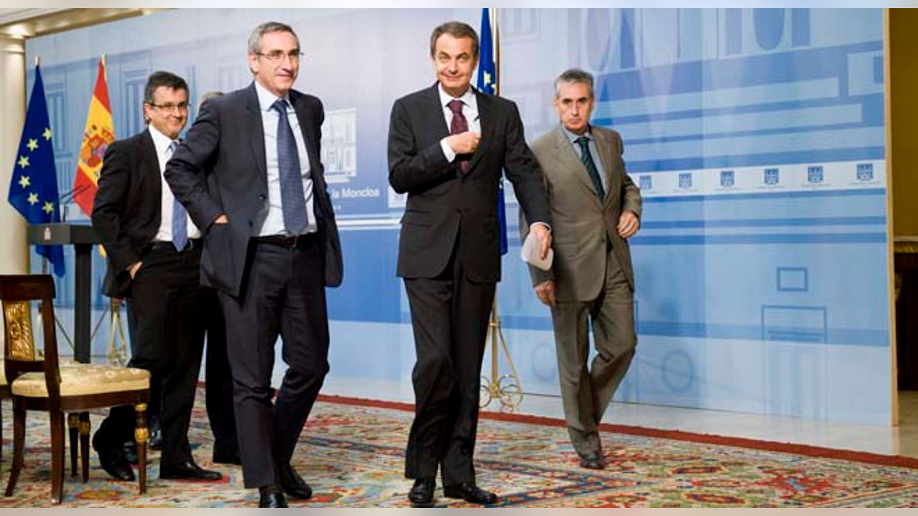 Spain's Prime Minister Jose Luis Rodriguez Zapatero, center, leaves after a press conference at the Moncloa Palace, in Madrid, Monday Sept. 26, 2011. Spain's prime minister dissolved Parliament on Monday, setting the stage for a Nov. 20 general election that is likely to focus on an economy saddled with 21 percent unemployment, anemic growth and gloomy future prospects. (AP Photo/Daniel Ochoa de Olza)