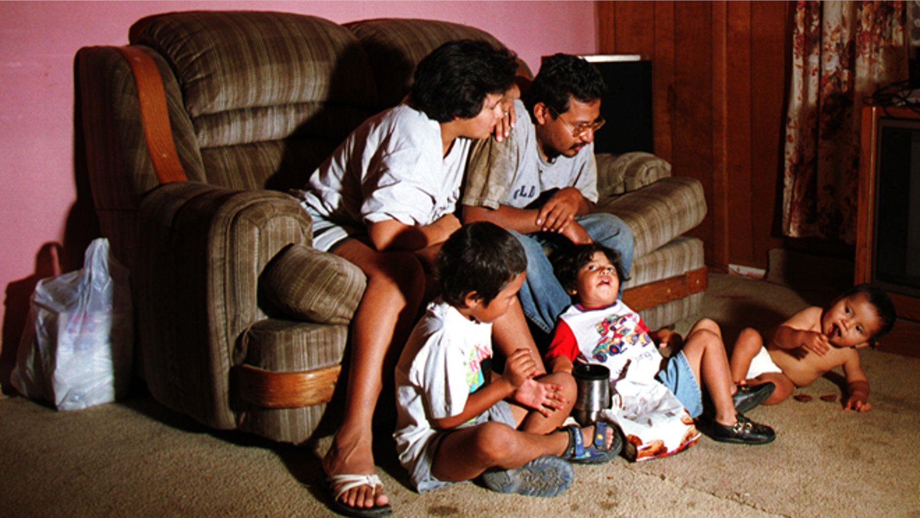 Lorenzo Alvarez, his wife Angelica Alvarez and their three children watch TV at their home in a colonia on the outskirts of El Paso, Texas. (Photo by Joe Raedle/Newsmakers)