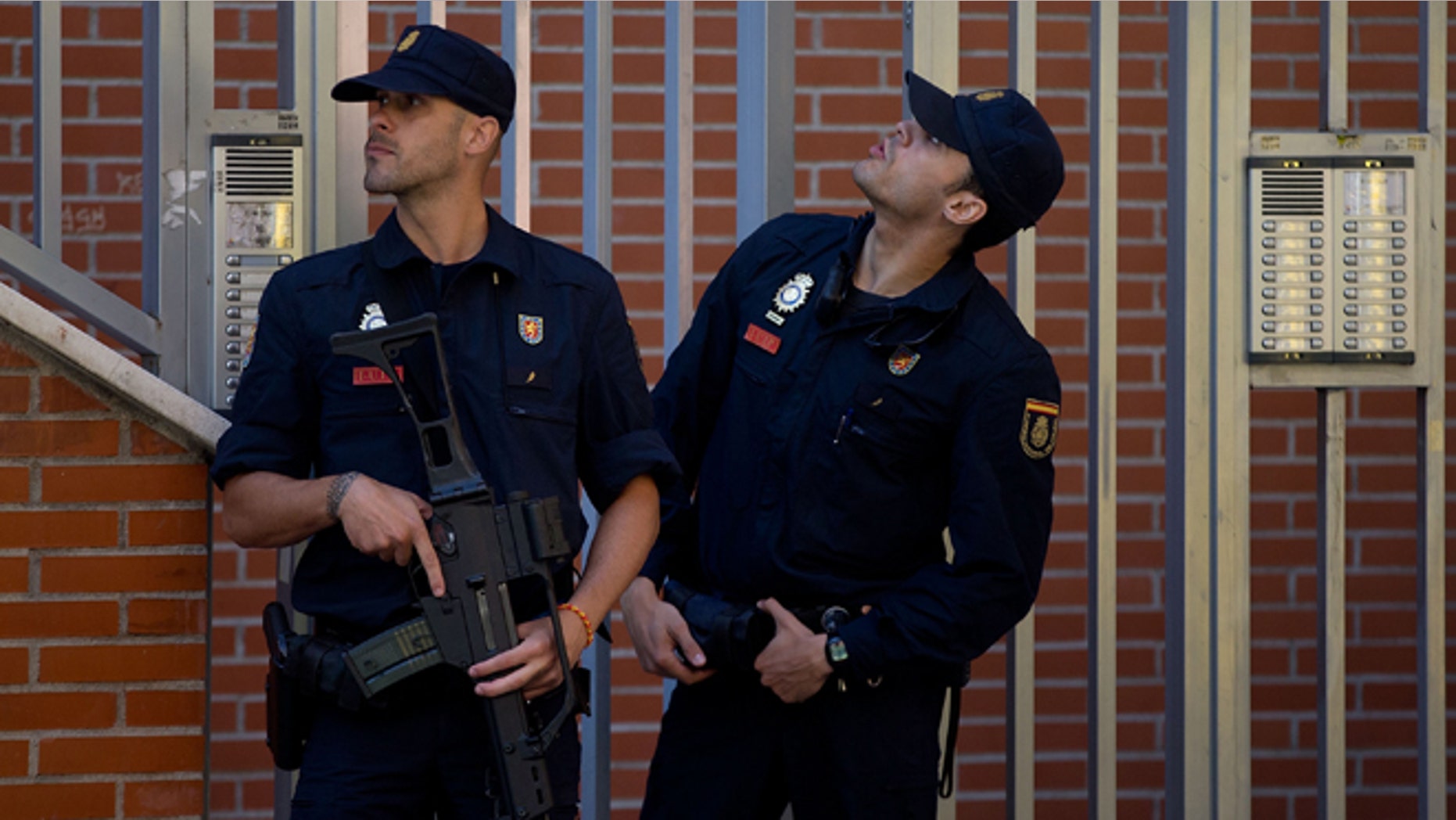 MADRID, SPAIN - JUNE 16: Two Spanish policemen guard a residence at Rutilo street during an operation against an international Jihadist recruiting network on June 16, 2014 in Madrid, Spain. Spanish Police this morning made eight arrests in raids against an Islamist cell believed to be recruiting Jihadists to fight in Syria and Iraq for ISIL (Islamic State in Iraq and the Levant)Terrorist Group. (Photo by Gonzalo Arroyo Moreno/Getty Images)