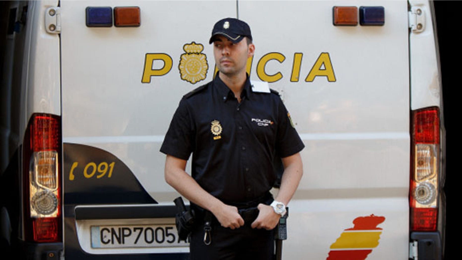 MADRID, SPAIN - SEPTEMBER 01: A policeman stands guard as a police van allegedly holding Brett and Naghemeh King, parents of five years old Ashya King arrives at the National Court on September 1, 2014 in Madrid, Spain. Ashya King, who has a brain tumour, was taken by his parents from a UK hospital against medical advice resulting in the parents arrest in Velez, Malaga on Saturday on an extradition warrant by UK police authorities. (Photo by Denis Doyle/Getty Images)