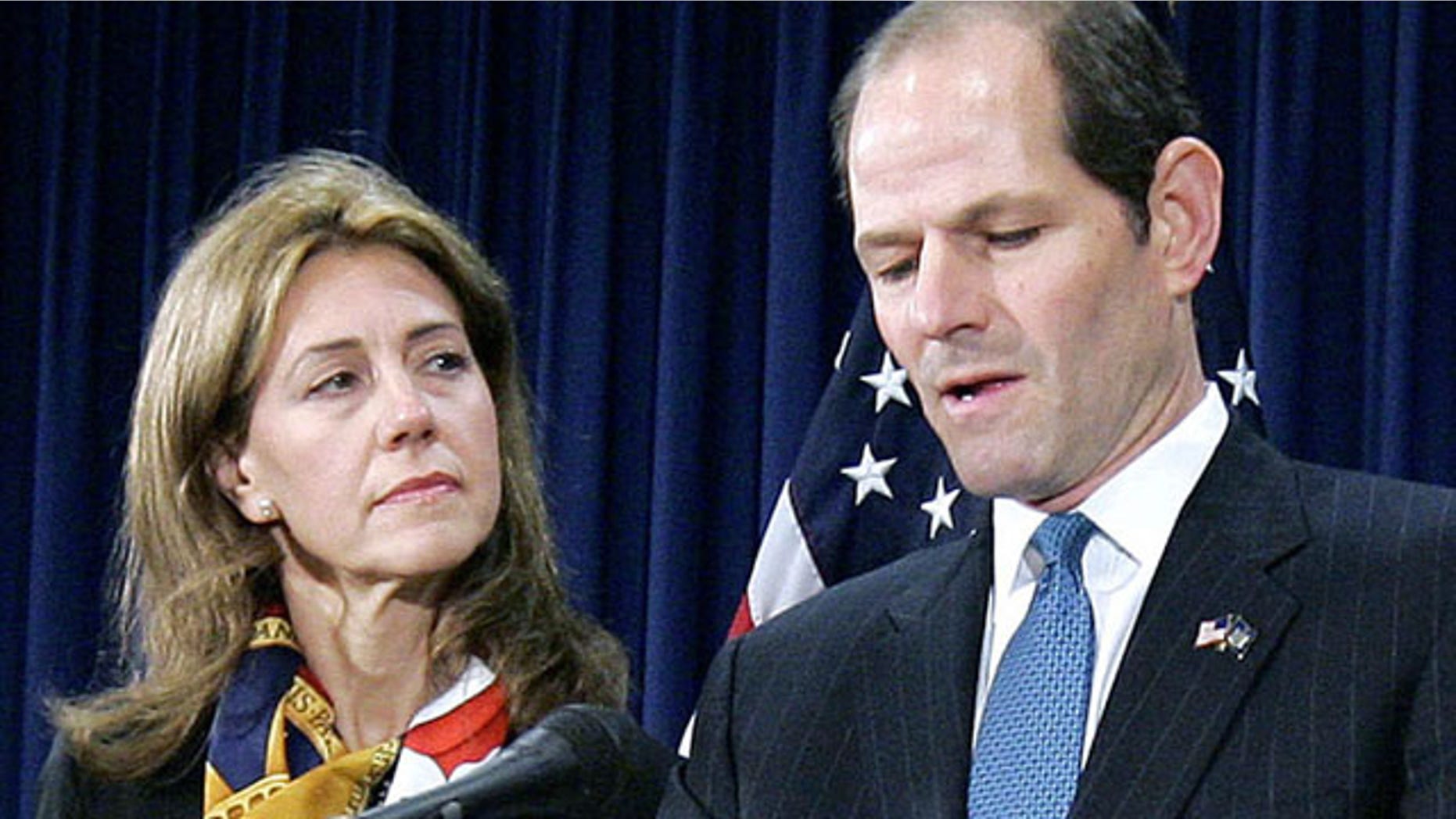 FILE - In this March 12, 2008, file photo, New York Gov. Eliot Spitzer announces his resignation amid a prostitution scandal as his wife Silda stands by at the governor’s office in New York. Spitzer and wife Silda Wall Spitzer announced Tuesday, Dec. 24, 2013, that their marriage of more than two decades is over. (AP Photo/Stephen Chernin, File)
