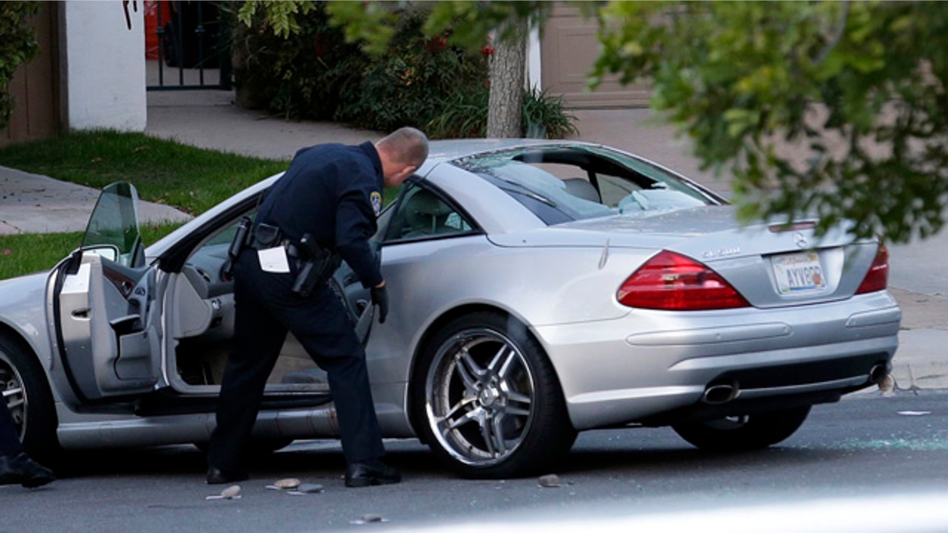 Feb. 10, 2015: Police examine the scene following a shooting in San Diego. CBS affiliate KFMB-TV says sports anchor Kyle Kraska was attacked Tuesday afternoon in the Scripps Ranch area of the city. (AP Photo/Gregory Bull)