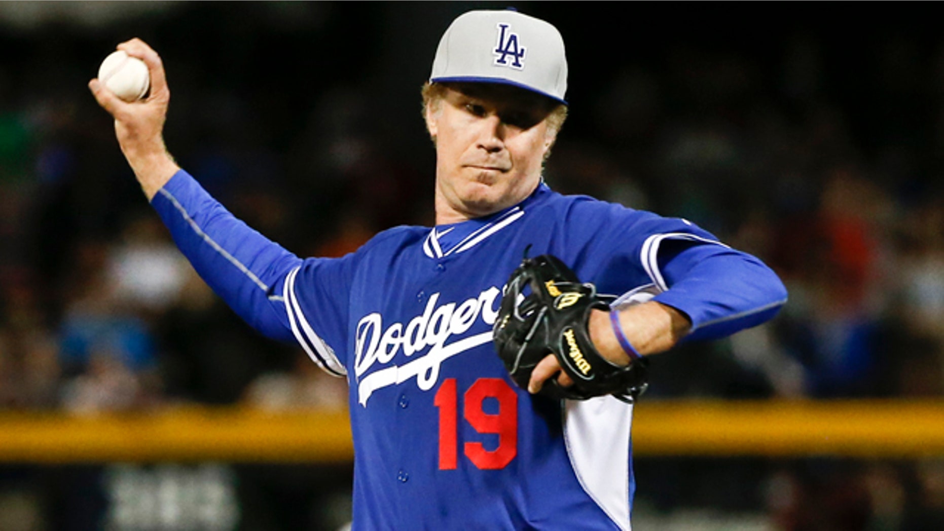 March 12, 2015: Actor Will Ferrell pitches for the Los Angeles Dodgers in a spring training baseball game against the San Diego Padres in Peoria, Ariz. (AP Photo/Lenny Ignelzi)