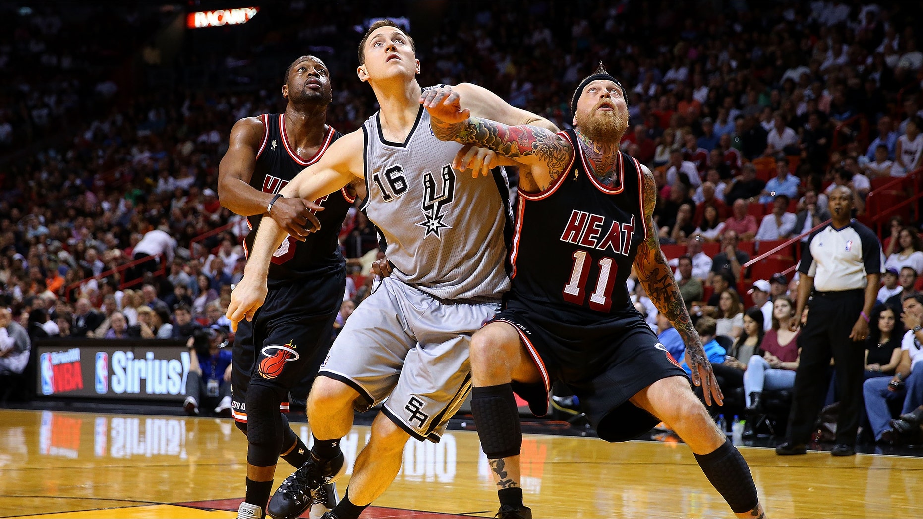 MIAMI, FL - JANUARY 26: Chris Andersen #11 and Dwyane Wade #3 of the Miami Heat box out Aron Baynes #16 of the San Antonio Spurs during a game at American Airlines Arena on January 26, 2014 in Miami, Florida. NOTE TO USER: User expressly acknowledges and agrees that, by downloading and/or using this photograph, user is consenting to the terms and conditions of the Getty Images License Agreement. Mandatory copyright notice: (Photo by Mike Ehrmann/Getty Images)