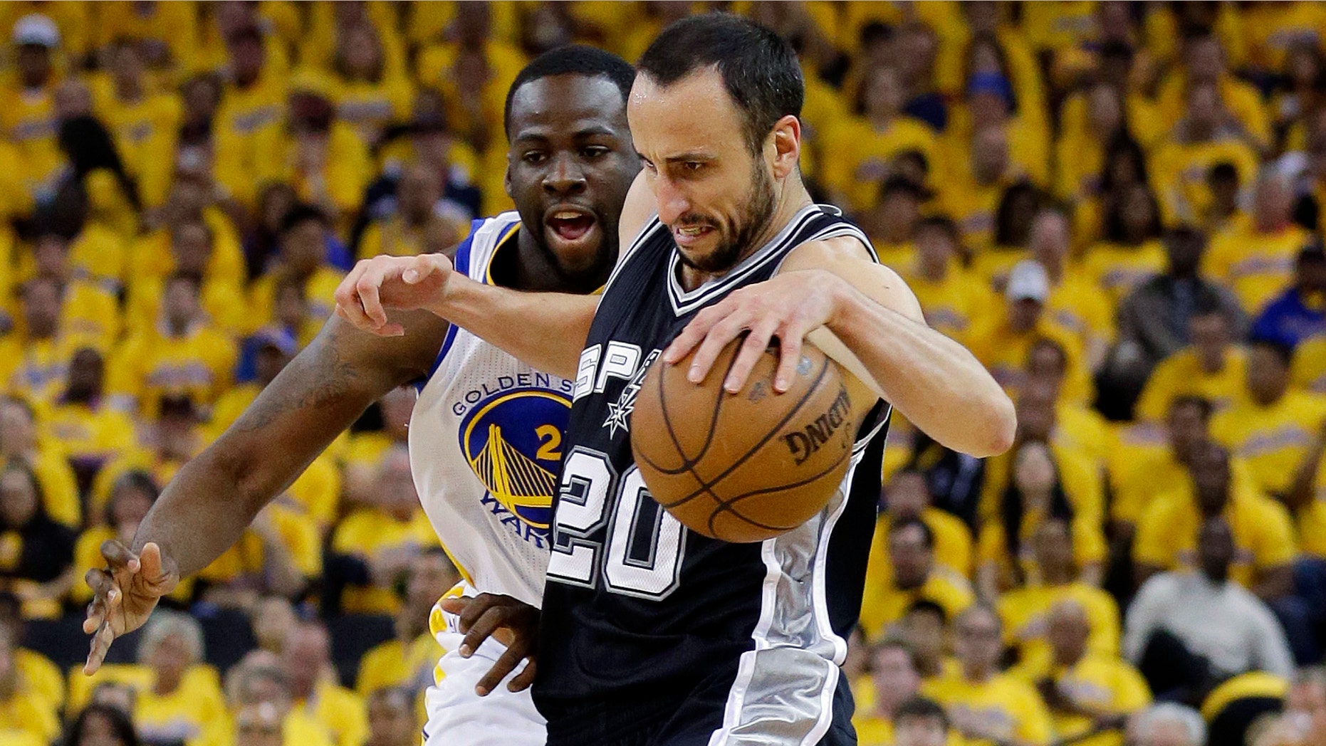 San Antonio Spurs Manu Ginobili drives past Golden State Warriors Draymond Green in Game 6 of a Western Conference semifinal NBA basketball playoff series in Oakland, Calif., May 16, 2013.