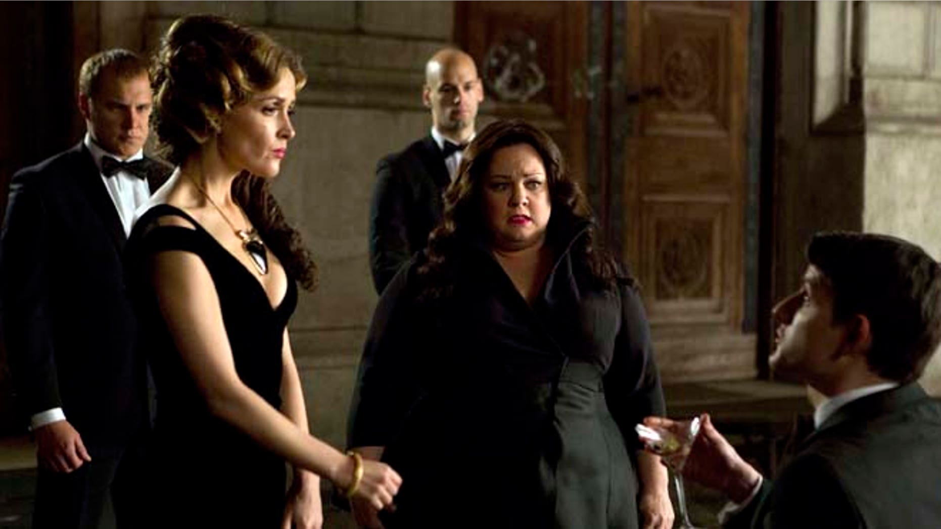 This photo provided by Twentieth Century Fox shows, Melissa McCarthy, second right, infiltrating an arms dealing ring led by Rose Byrne, left, in a scene from the film, "Spy."