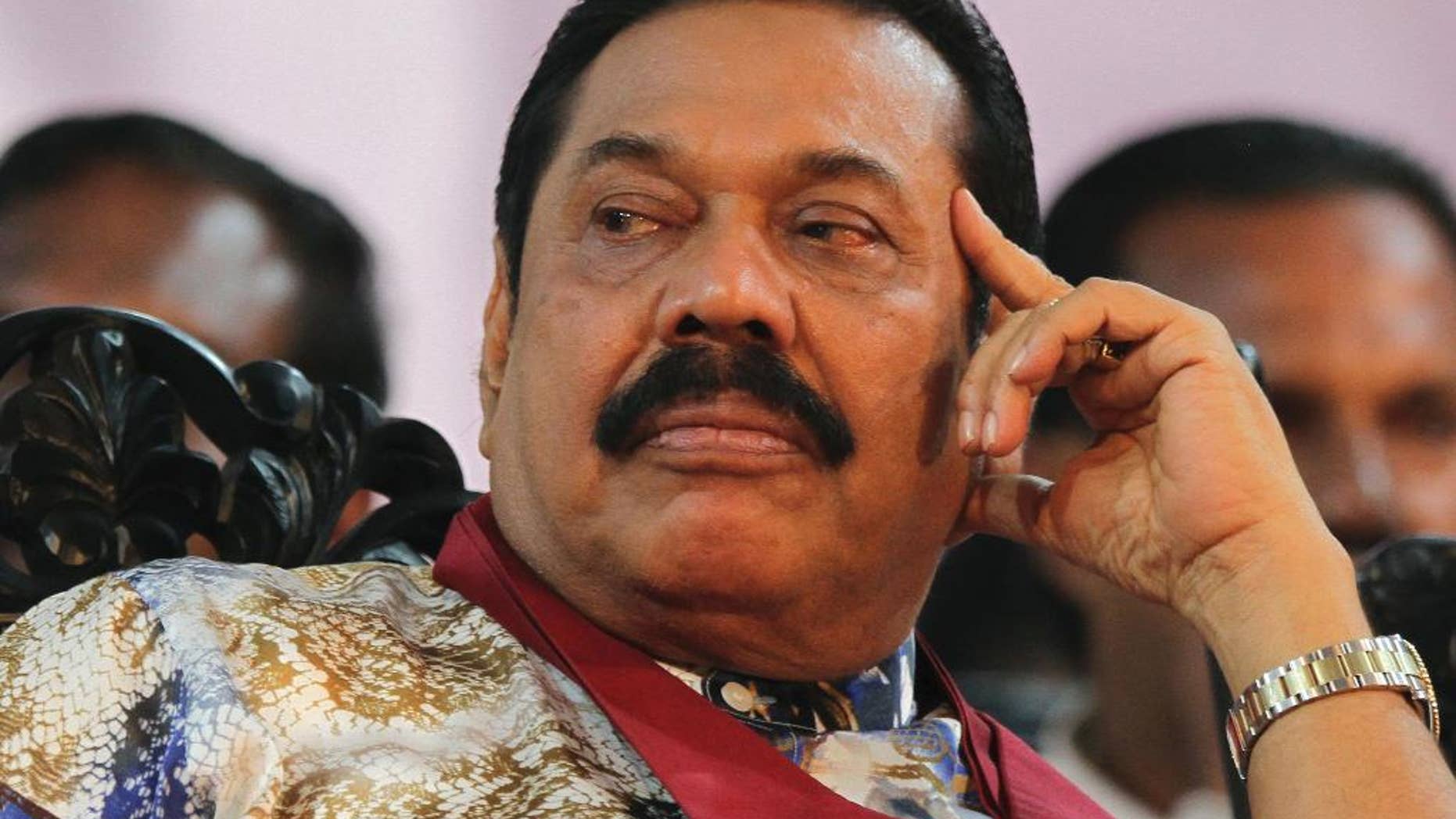 FILE - In this Jan. 5, 2015 file photo, then-Sri Lankan President Mahinda Rajapaksa attends his final public rally for the presidential elections in Kesbewa, southeast of Colombo, Sri Lanka. Mangala Samaraweera, the spokesman for new President Maithripala Sirisena, said Sunday, Jan. 11, 2015, Sri Lanka's new government will investigate an alleged attempt by former President Rajapaksa to stage a coup to stay in power when results showed he was losing last week's election. (AP Photo/Sanka Gayashan, File)