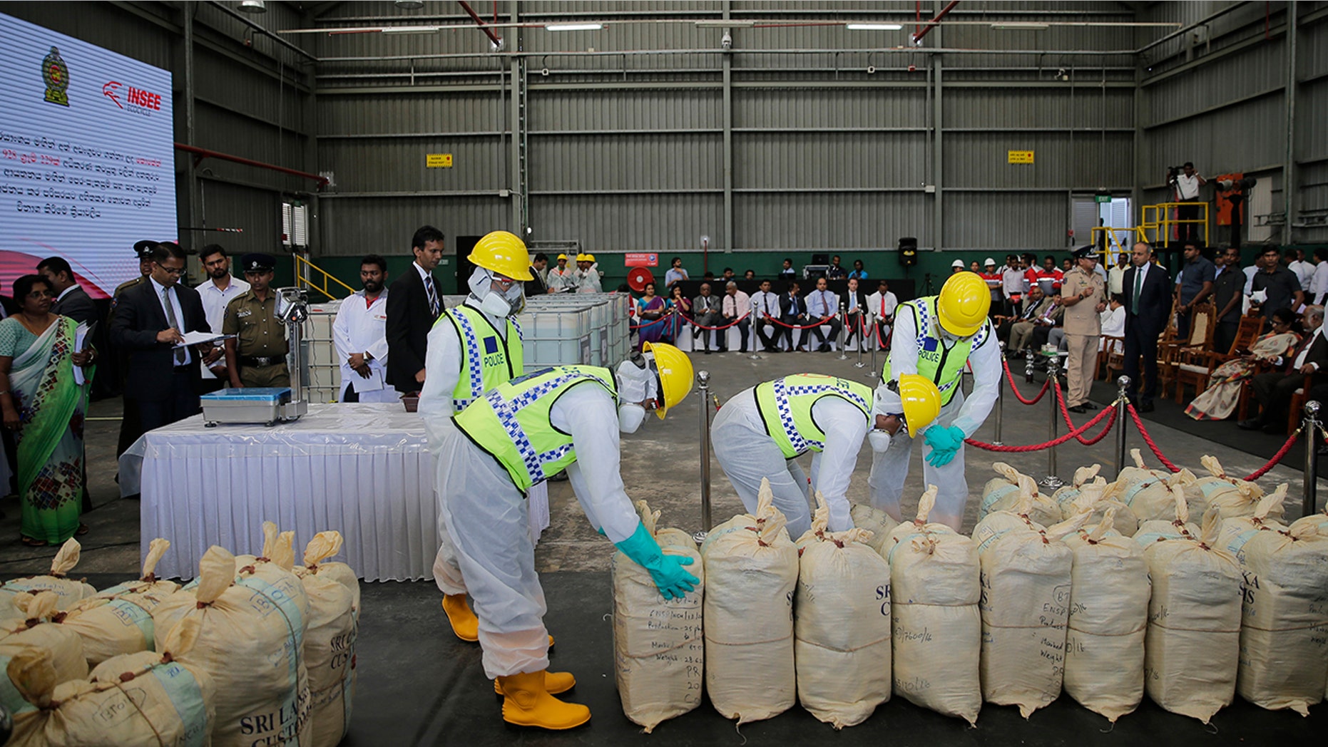 Sri Lankan police officers in protective outfits prepare to destroy a haul of seized cocaine during a ceremony at an industrial facility in Katunayaka, outskirts of Colombo, Sri Lanka in January.
