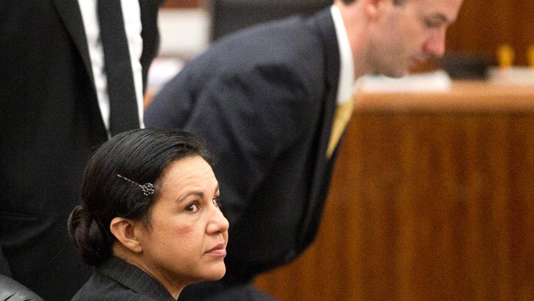 Ana Lilia Trujillo, left, sits in the courtroom before opening arguments in her trial, Monday, March 31, 2014, in Houston. Trujillo, 45, is charged with murder, accused of killing her 59-year-old boyfriend, Alf Stefan Andersson, at his Museum District high-rise condominium in June 2013. (AP Photo/Houston Chronicle, Brett Coomer)