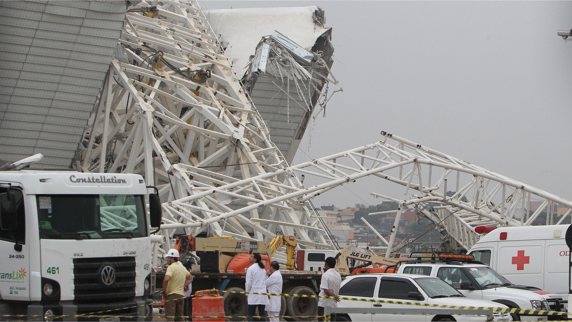 SAO PAULO, BRAZIL - NOVEMBER 27: Personnel survey the damage at the site of a crane collapse during construction at Itaquerao Stadium on November 27, 2013 in Sao Paulo, Brazil. According to reports, at least two workers were killed in the accident which caused major damage. The stadium is scheduled to host the opening ceremony of the World Cup in 2014. (Photo by Ricardo Bufolin/Getty Images)