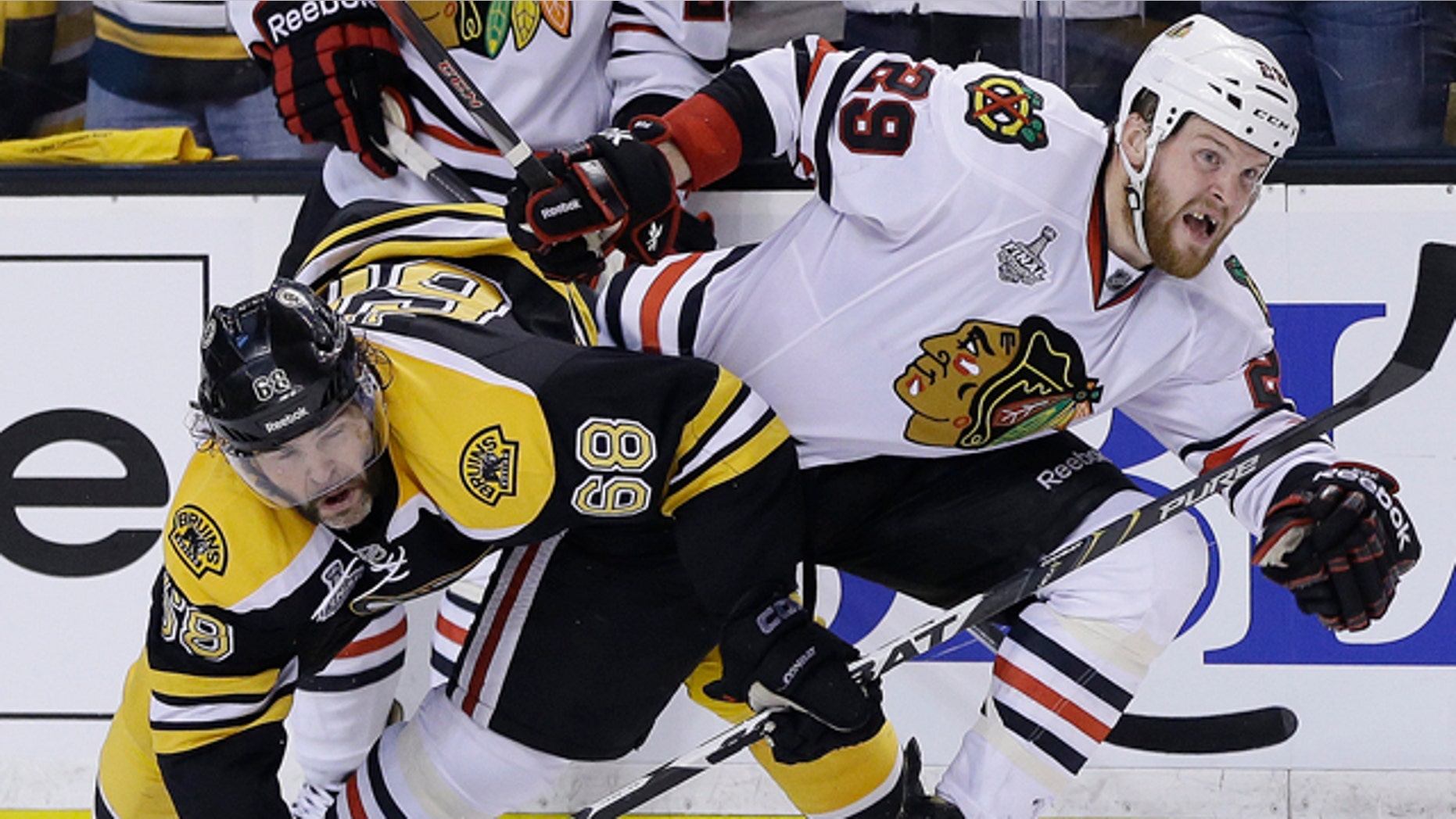 June 17, 2013: Boston Bruins right wing Jaromir Jagr (68), of the Czech Republic, ties up Chicago Blackhawks left wing Bryan Bickell (29) during the third period in Game 3 of the NHL hockey Stanley Cup Finals in Boston.