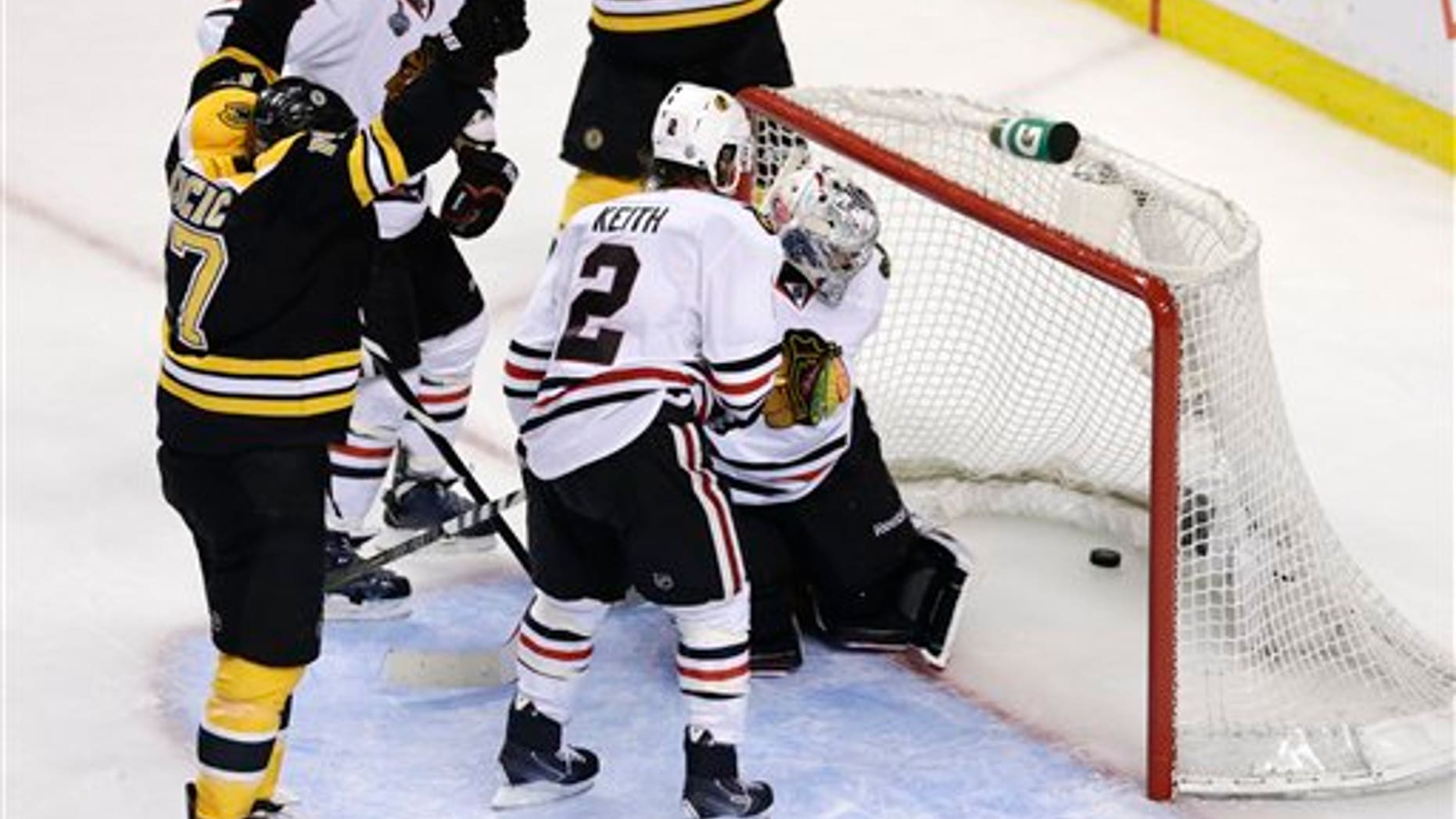 June 24, 2013: Boston Bruins left wing Milan Lucic, left, reacts after scoring past Chicago Blackhawks defenseman Duncan Keith (2) and goalie Corey Crawford, hidden during the third period in Game 6 of the NHL hockey Stanley Cup Finals.