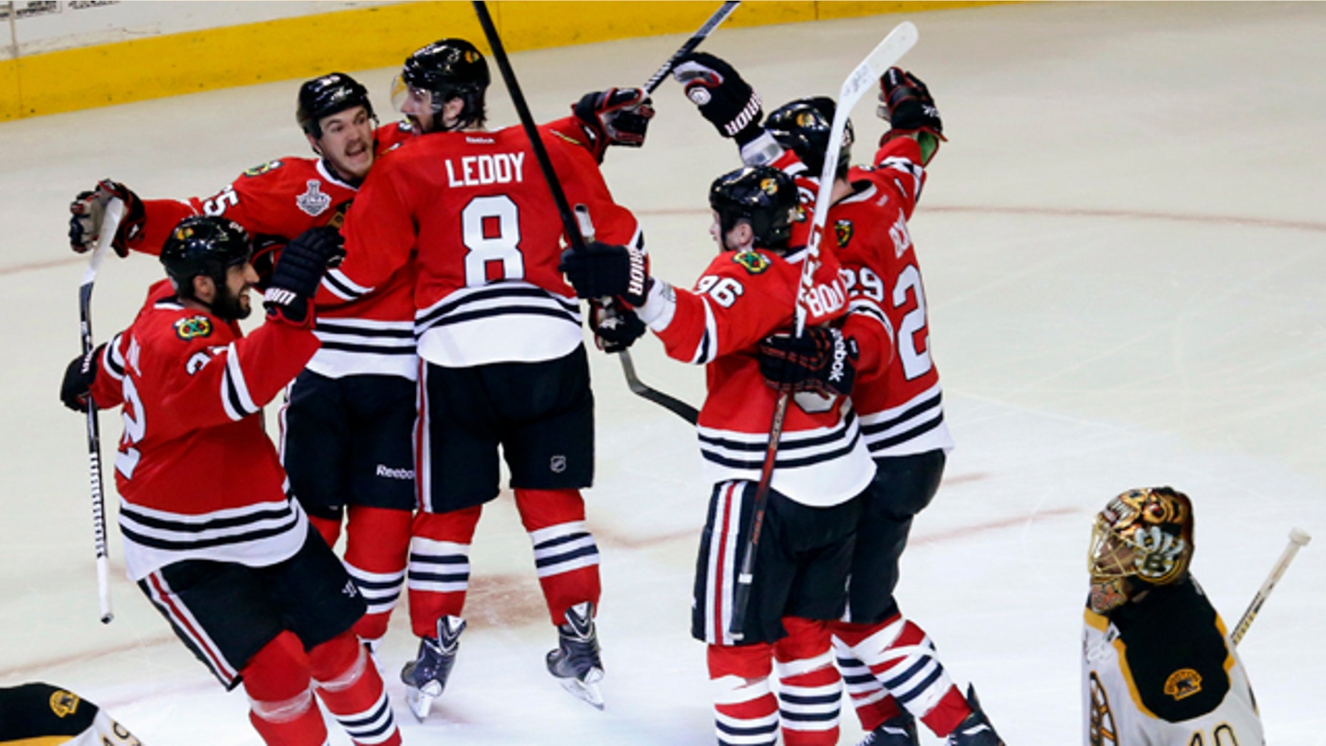 June 13, 2013: Chicago Blackhawks center Andrew Shaw, second from left, celebrates with his teammates after scoring the winning goal during the third overtime period of Game 1 in their NHL Stanley Cup Final hockey series against the Boston Bruins.