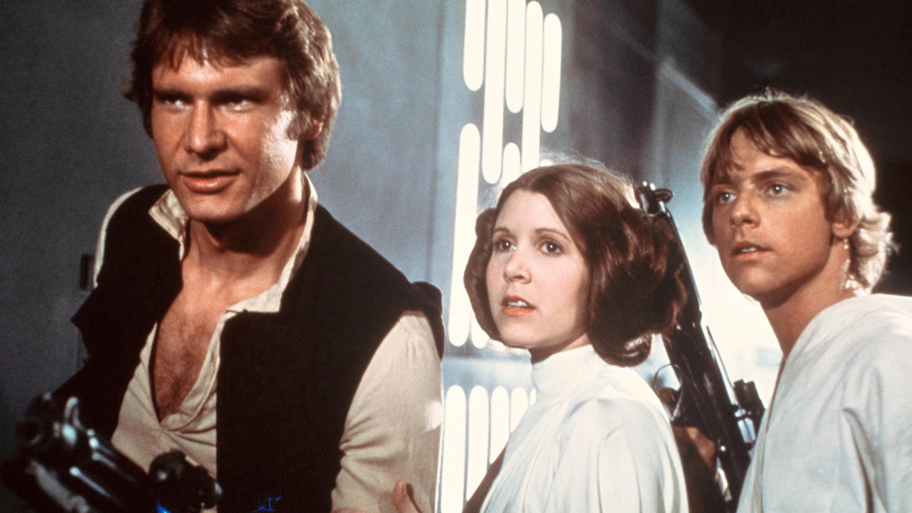 This publicity film image provided by 20th Century-Fox Film Corporation shows, from left, Harrison Ford as Han Solo, Carrie Fisher as Princess Leia Organa and Mark Hamill as Luke Skywalker in a scene from the "Star Wars" movie released by 20th Century-Fox in 1977. The classic Star Wars film that launched a science fiction empire is being dubbed in the Navajo language, with casting calls scheduled Monday, April 29, 2013, in Burbank, Calif., and on May 3 and 4 at the Navajo Nation Museum in Window Rock. Potential actors don't have to sound exactly like Princess Leia, Luke Skywalker or Han Solo, but should be able to deliver the lines with character. (AP Photo/20th Century-Fox Film Corporation)