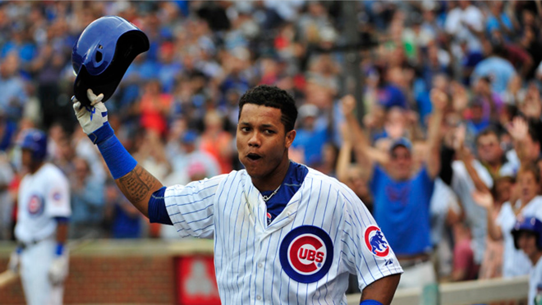 CHICAGO, IL - SEPTEMBER 18: Starlin Castro #13 of the Chicago Cubs tips his helmet to the fans after hitting three-run home run against the St. Louis Cardinals during the sixth inning on September 18, 2015 at Wrigley Field in Chicago, Illinois. (Photo by David Banks/Getty Images)