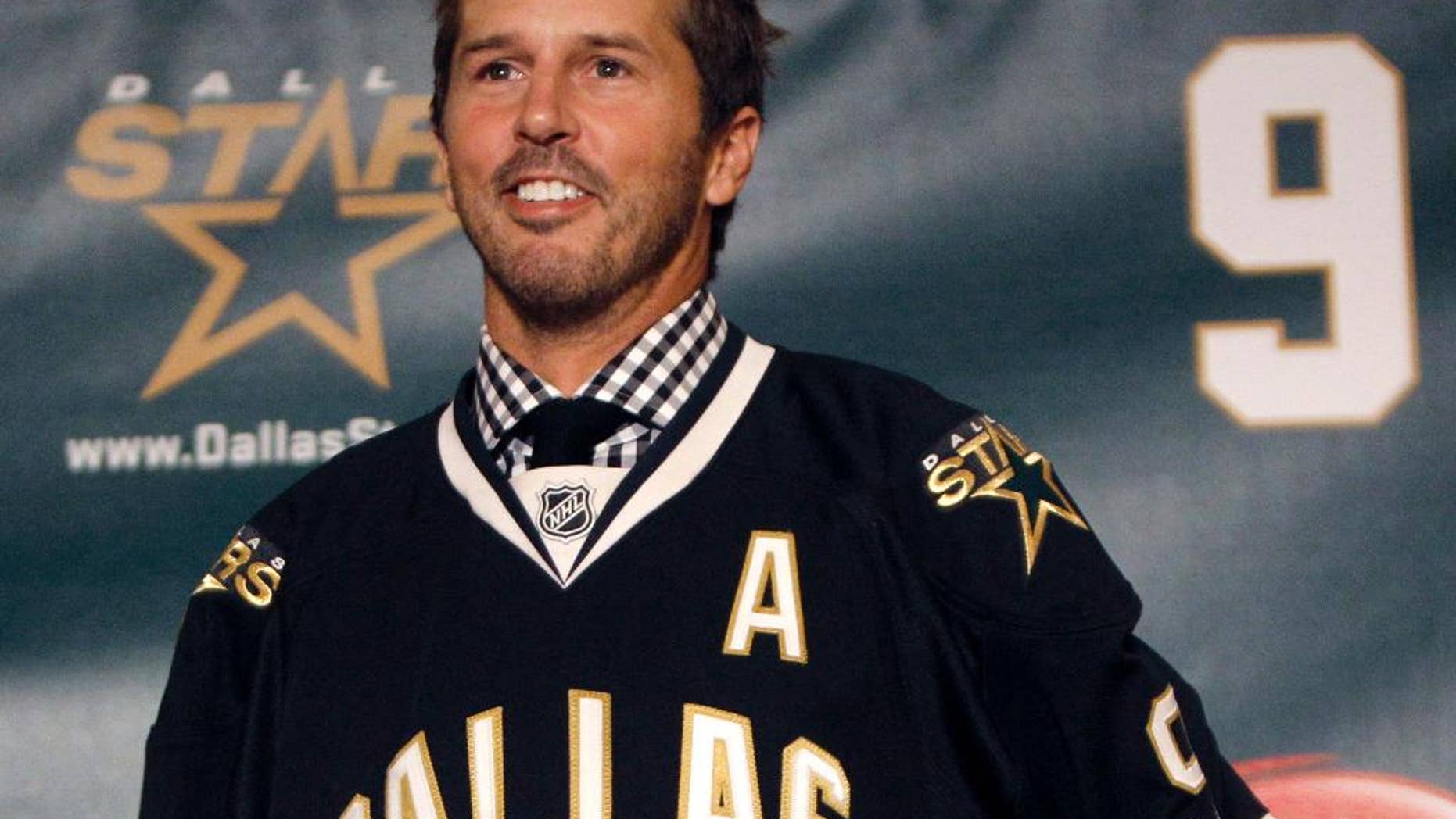 FILE - In this Sept. 23, 2011, file photo, NHL hockey player Mike Modano wears a Dallas Stars jersey during a news conference announcing his retirement in Dallas. Modano had several tearful farewells as his playing days wound down. The guy who made hockey cool in Dallas figures he'll get emotional again for the final ceremony: retiring his iconic No. 9 during the Stars' game against Minnesota on Saturday, March 8. (AP Photo/LM Otero, File)