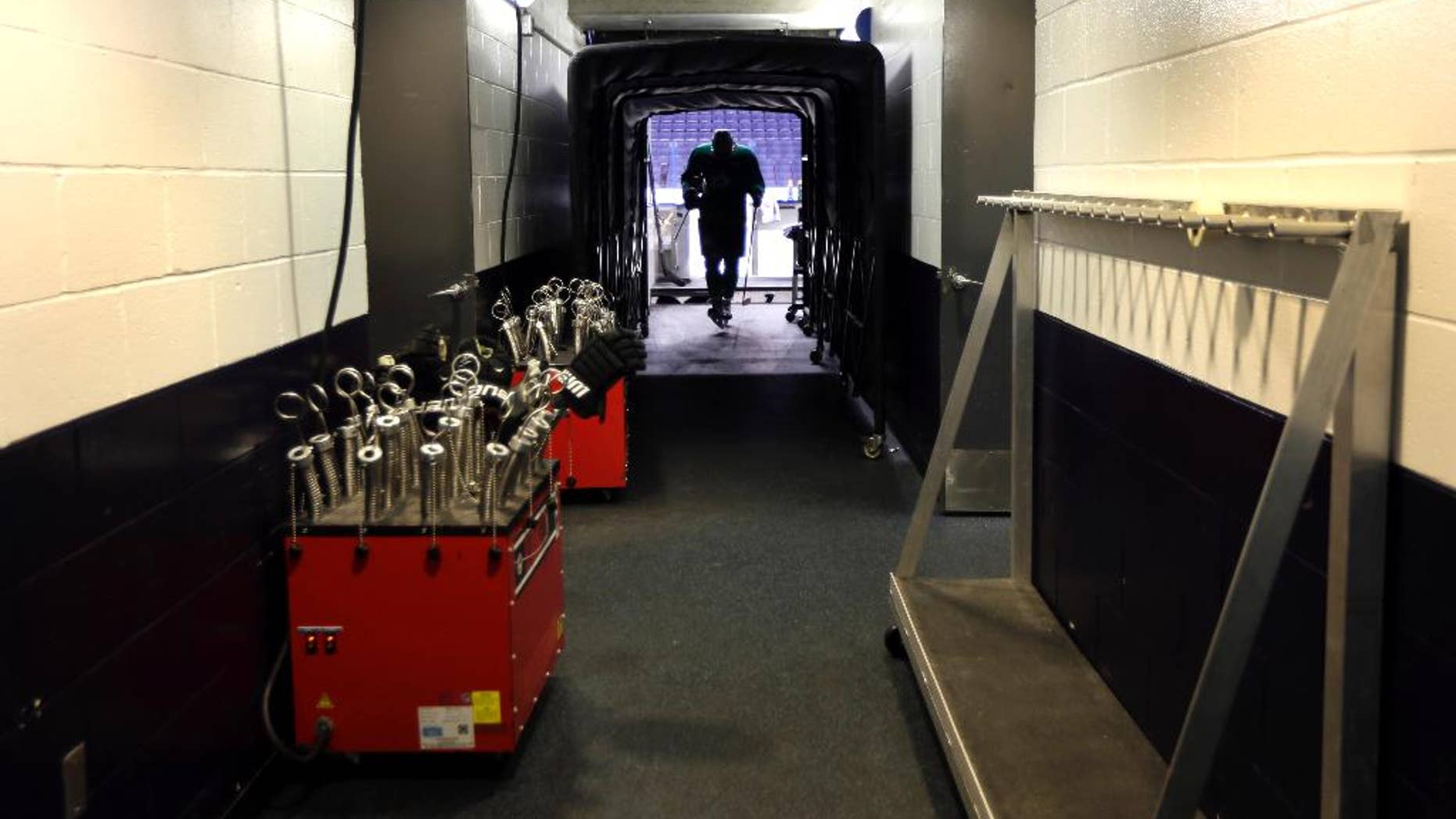 Dallas Stars' Valeri Nichushkin walks through a tunnel leading to the Stars' locker room following an NHL hockey practice Tuesday, March 11, 2014, in St. Louis. Dallas Stars' Rich Peverley is undergoing testing to determine what triggered his collapse during a game Monday night in Dallas. The Stars are scheduled to play the St. Louis Blues tonight in St. Louis. (AP Photo/Jeff Roberson)