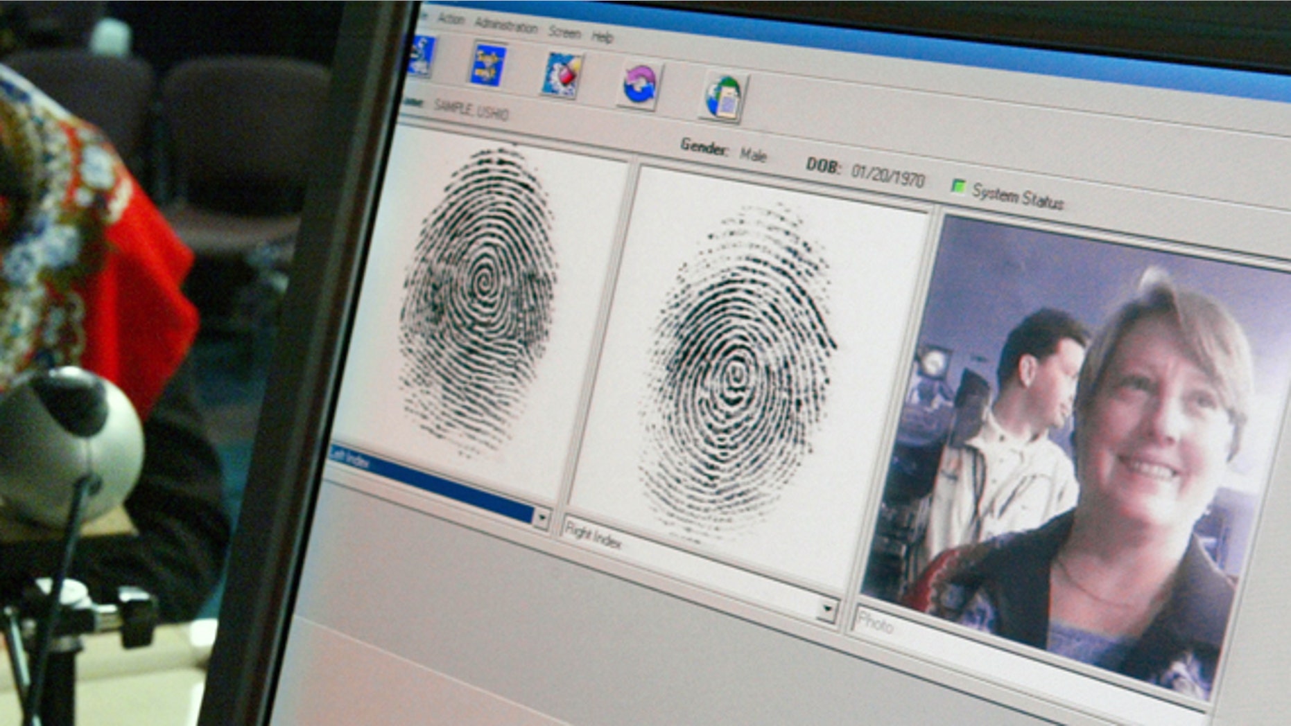 WASHINGTON - OCTOBER 28: Penelope Smith, of the US-VISIT Program, demonstrates the process of inkless fingerprints scanning during a news conference on the program October 28, 2003 in Washington, DC. The U.S. Department of Homeland Security unveiled the US-VISIT Program, which will capture more complete arrival and departure data, such as fingerprints and mug shots, at airports and seaports from visitors who require a visa to enter the United States. (Photo by Alex Wong/Getty Images)