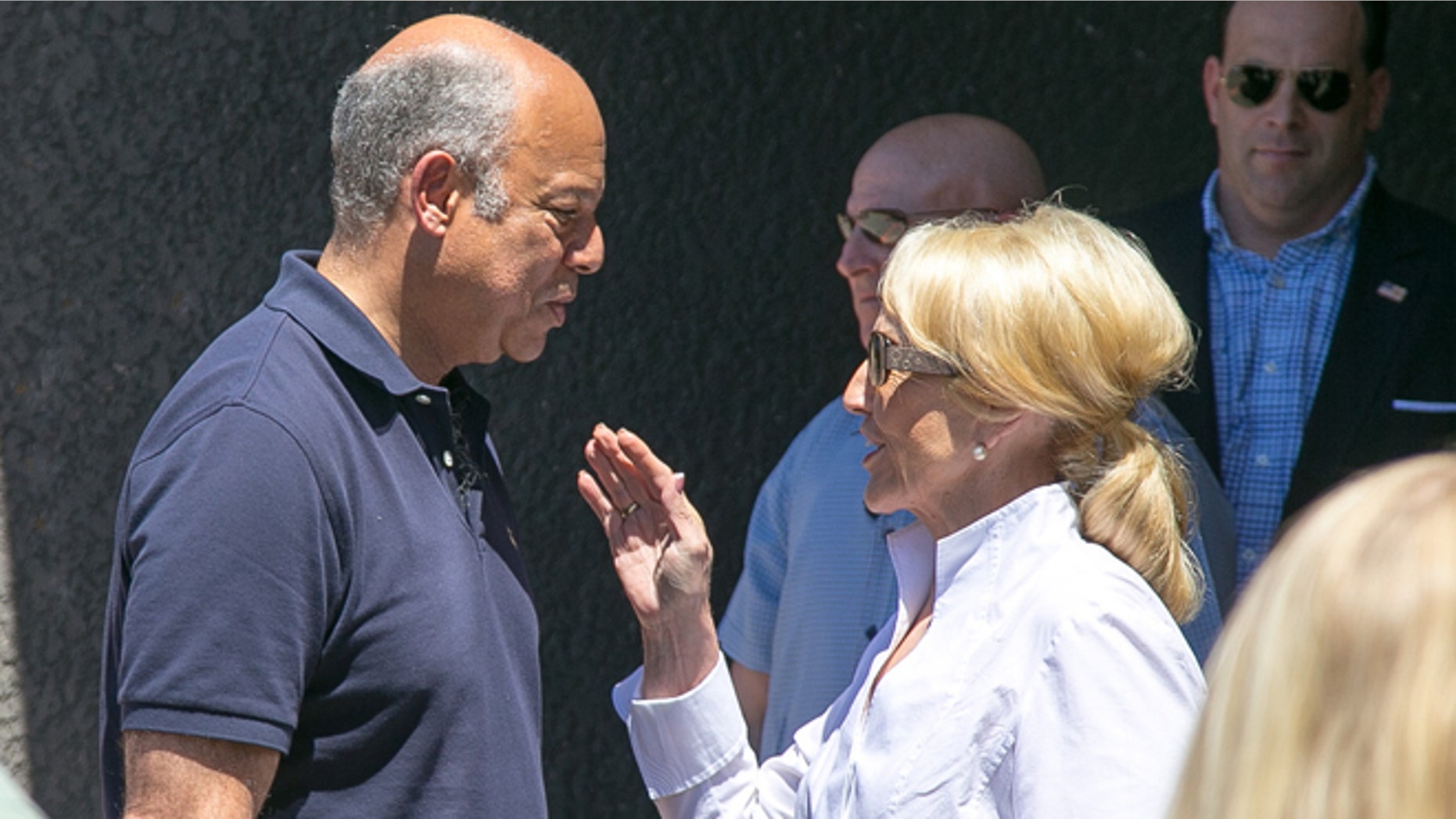 Secretary of Homeland Security Jeh Johnson, left, talks with Arizona Gov. Jan Brewer, right, after visiting the U.S. Customs and Border Protection facilities to talk to some of the unaccompanied children that crossed the border in Nogales on Wednesday, June 25, 2014. (AP Photo/The Arizona Republic, Michael Schennum)