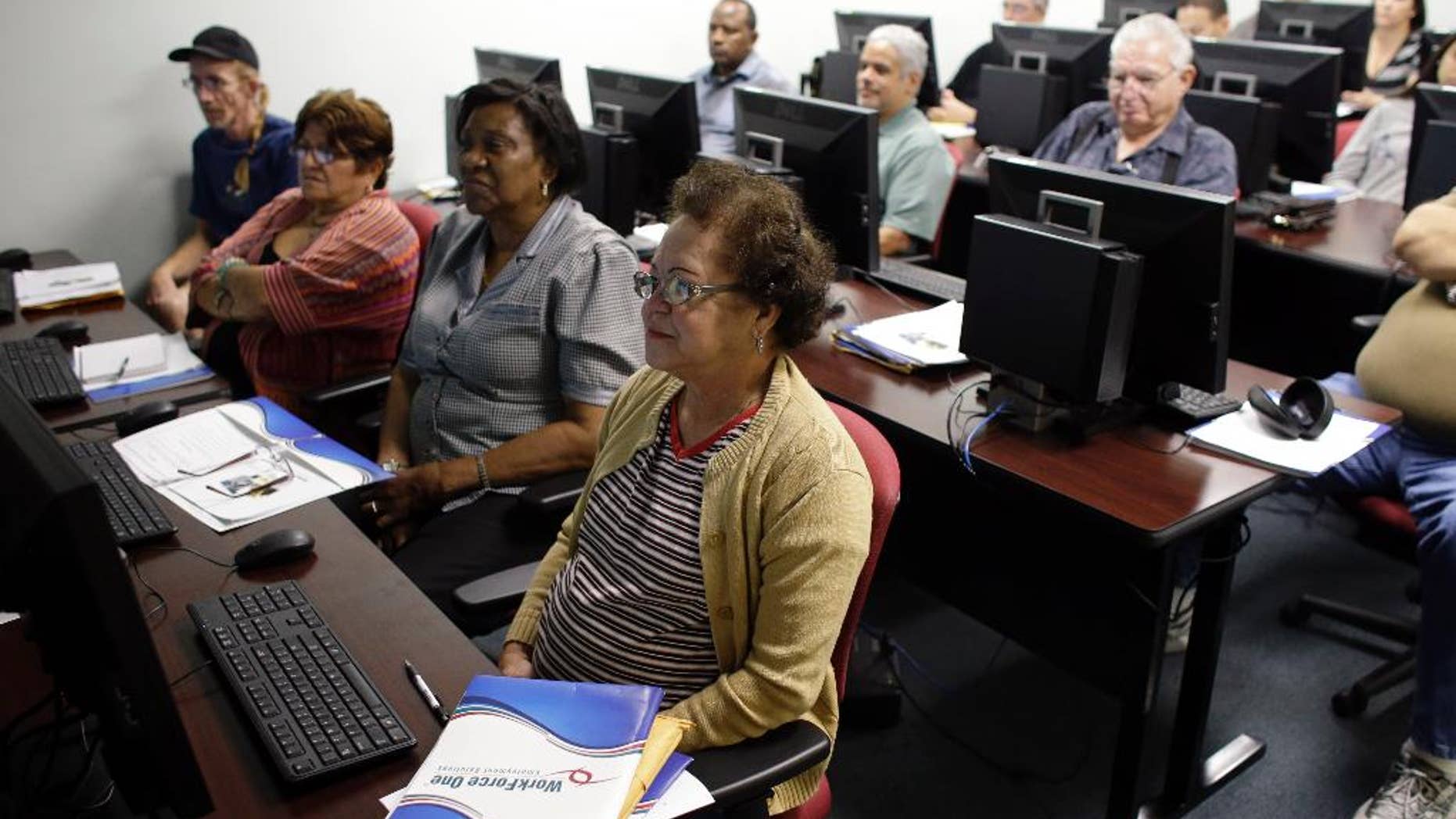 In this Feb. 6 2014 photo, Margarita Sanchez, 72, of Hollywood, Fla., front, listens during a job search workshop at WorkForce One in Davie, Fla. The government reports on state unemployment rates for January on Monday, March 17, 2014. (AP Photo/Lynne Sladky, File)