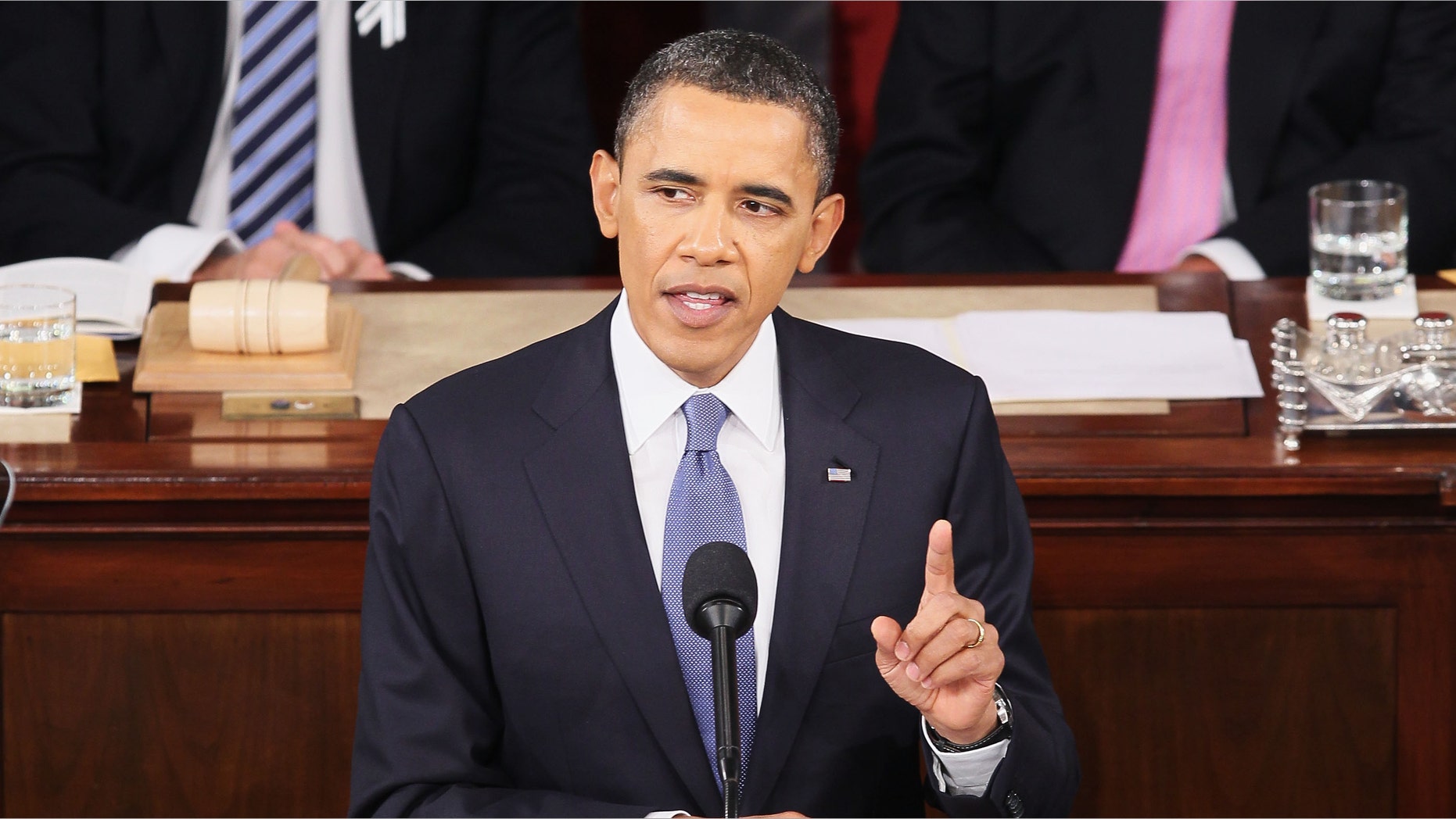 FILE U.S. President Barack Obama, flanked by Vice President Joe Biden (L) and Speaker of the House John Boehner (R-OH), addresses a Joint Session of Congress while delivering his State of the Union speech January 25, 2011 in Washington, DC. During his speech Obama was expected to focus on the U.S. economy and increasing education and infrastructure funding while proposing a three-year partial freeze of domestic programs and $78 billion in military spending cuts. (Photo by Alex Wong/Getty Images) *** Local Caption ***