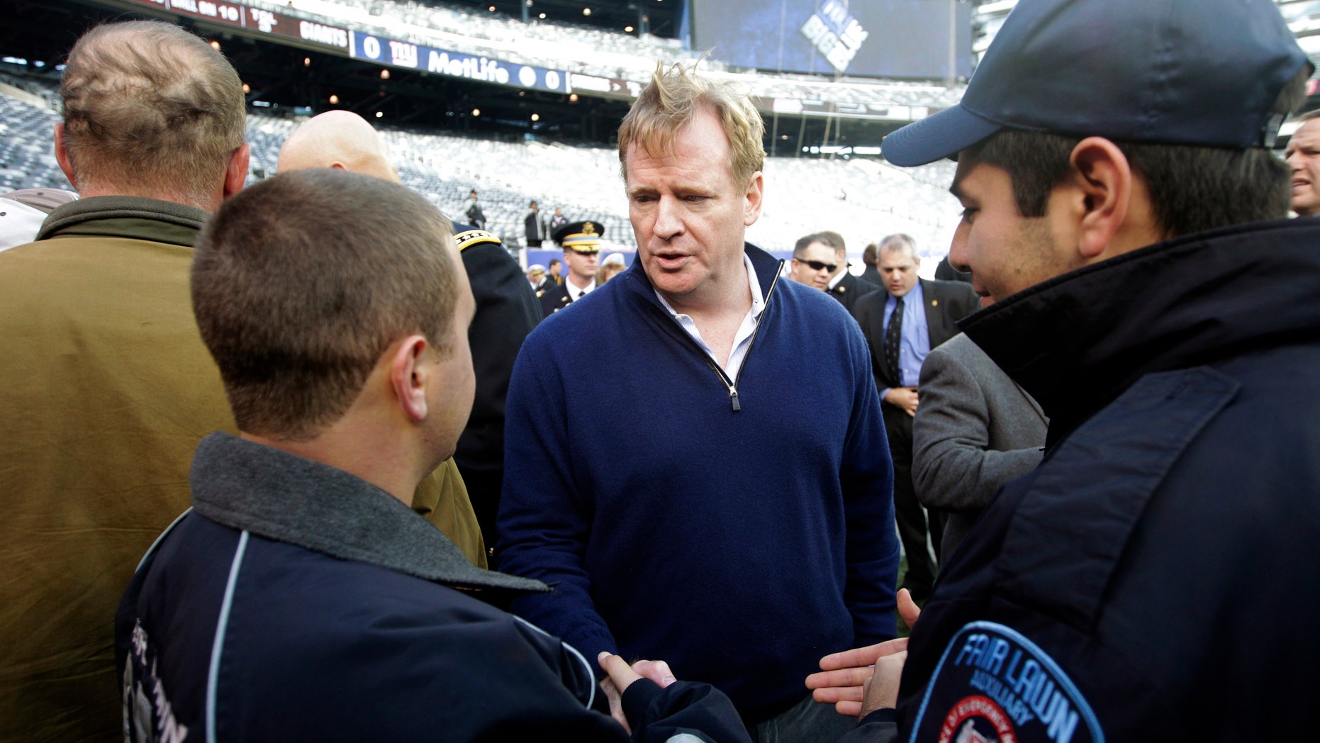 Nov. 4, 2012: Superstorm Sandy first responders Geovanny Buitron, right, and Steve Shore, left, talk to NFL Commissioner Roger Goodell before a football game between the New York Giants and the Pittsburgh Steelers in East Rutherford, N.J.