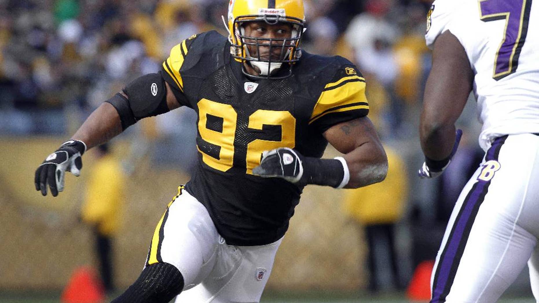 FILE - In this Dec. 27, 2009, file photo, Pittsburgh Steelers linebacker James Harrison (92) rushes against the Baltimore Ravens during an NFL football game in Pittsburgh. Harrison is itching to get back to work. The commute could be an easy one. The five-time Pro Bowl linebacker posted a thinly veiled message via Instagram on Monday night that hinted at an imminent return to the Pittsburgh Steelers. (AP Photo/Keith Srakocic, File)