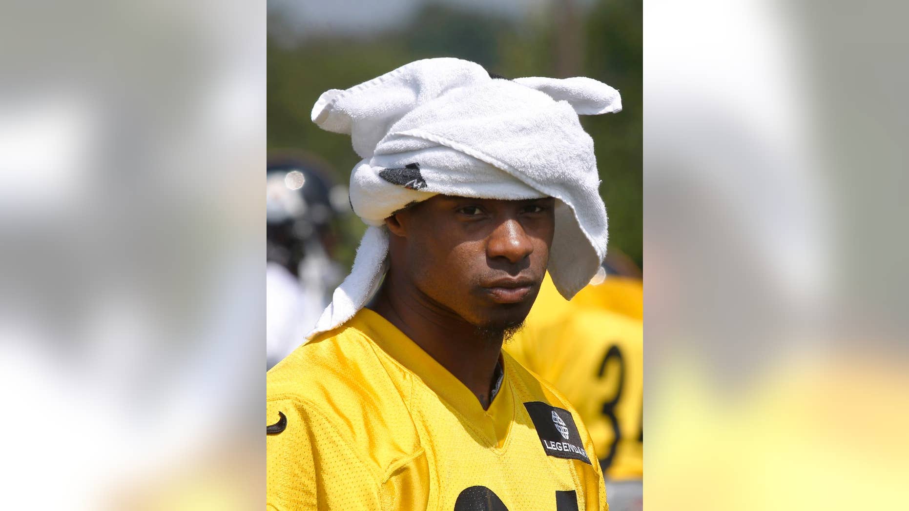 Pittsburgh Steelers cornerback Ike Taylor (24) uses a towel for a hat during NFL football training camp in Latrobe, Pa., on Monday, Aug. 4, 2014 . (AP Photo/Keith Srakocic)