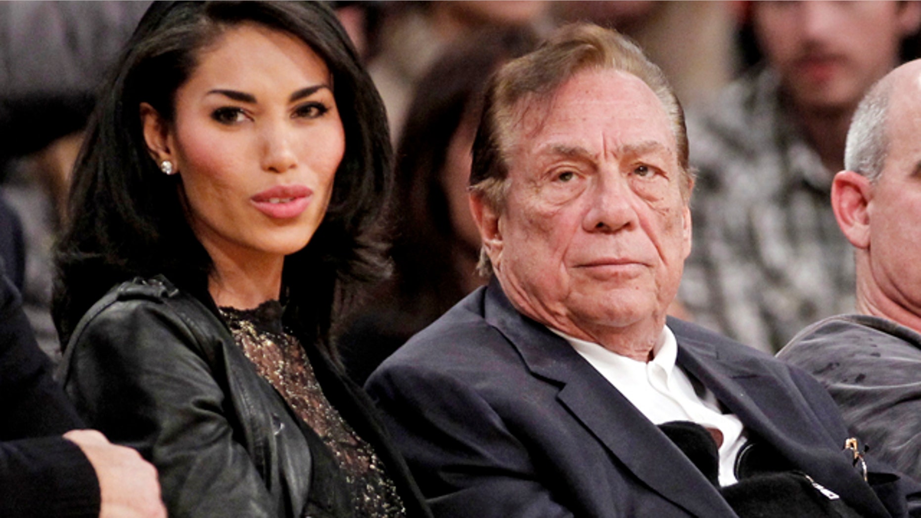 FILE - In this Dec. 19, 2011, file photo, Los Angeles Clippers owner Donald Sterling, right, sits with V. Stiviano as they watch the Clippers play the Los Angeles Lakers during an NBA basketball game in Los Angeles. (AP Photo/Danny Moloshok, File)