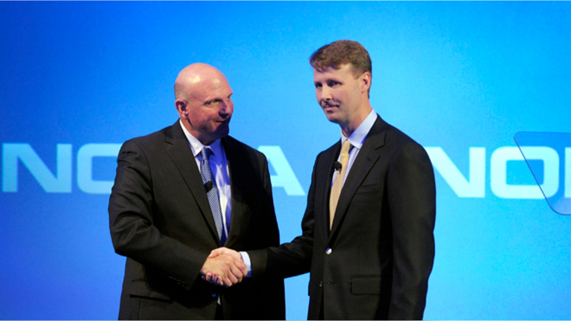 Microsoft CEO Steve Ballmer shakes hands with Nokia's Chairman of the Board Risto Siilasmaa (R) during the news conference of Finnish mobile phone manufacturer Nokia in Espoo, September 3, 2013.