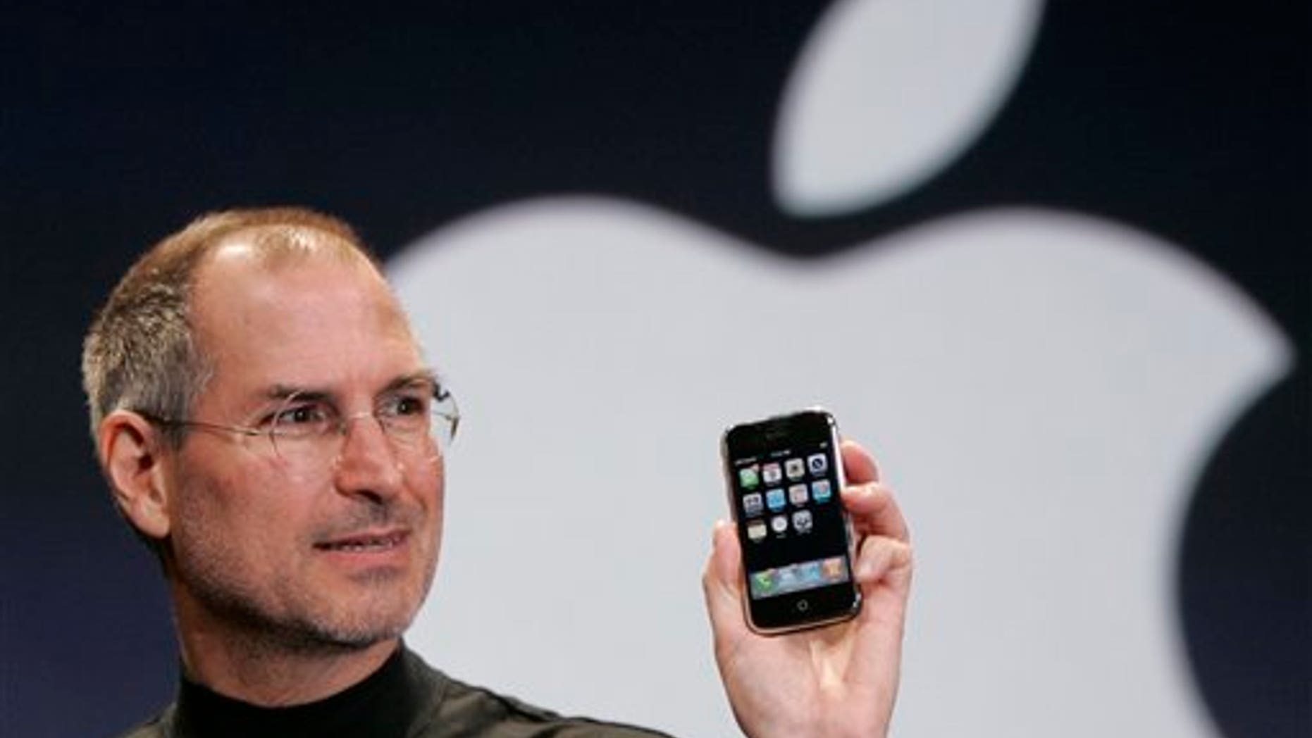 Apple co-founder Steve Jobs shows off an early iteration of the iPhone in 2007.