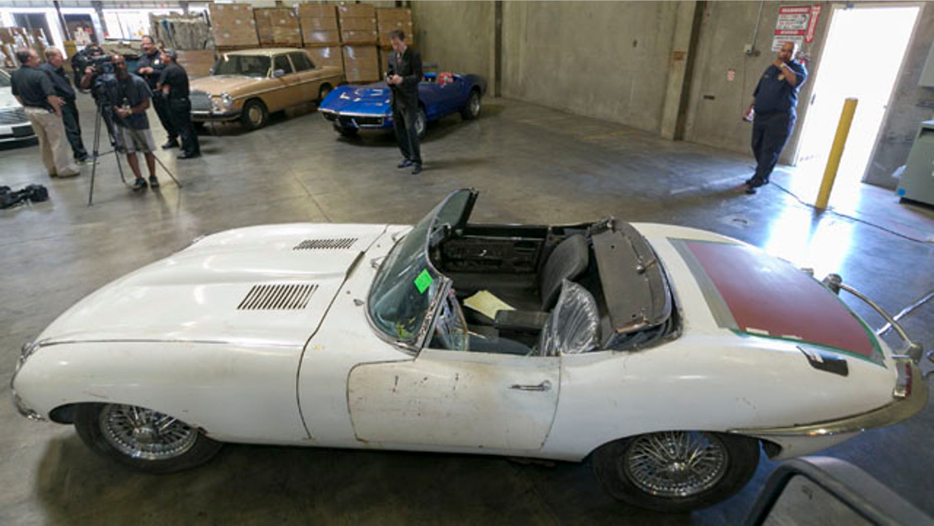 September 17, 2014: A 1967 Jaguar XK-E convertible that was stolen 46 years ago is shown to the media by the U.S. Customs and Protection agency in Carson, Calif. The car was recovered at the Port of Long Beach by the California Highway Patrol along with four other cars in a container en route to the Netherlands. (AP Photo/Damian Dovarganes)