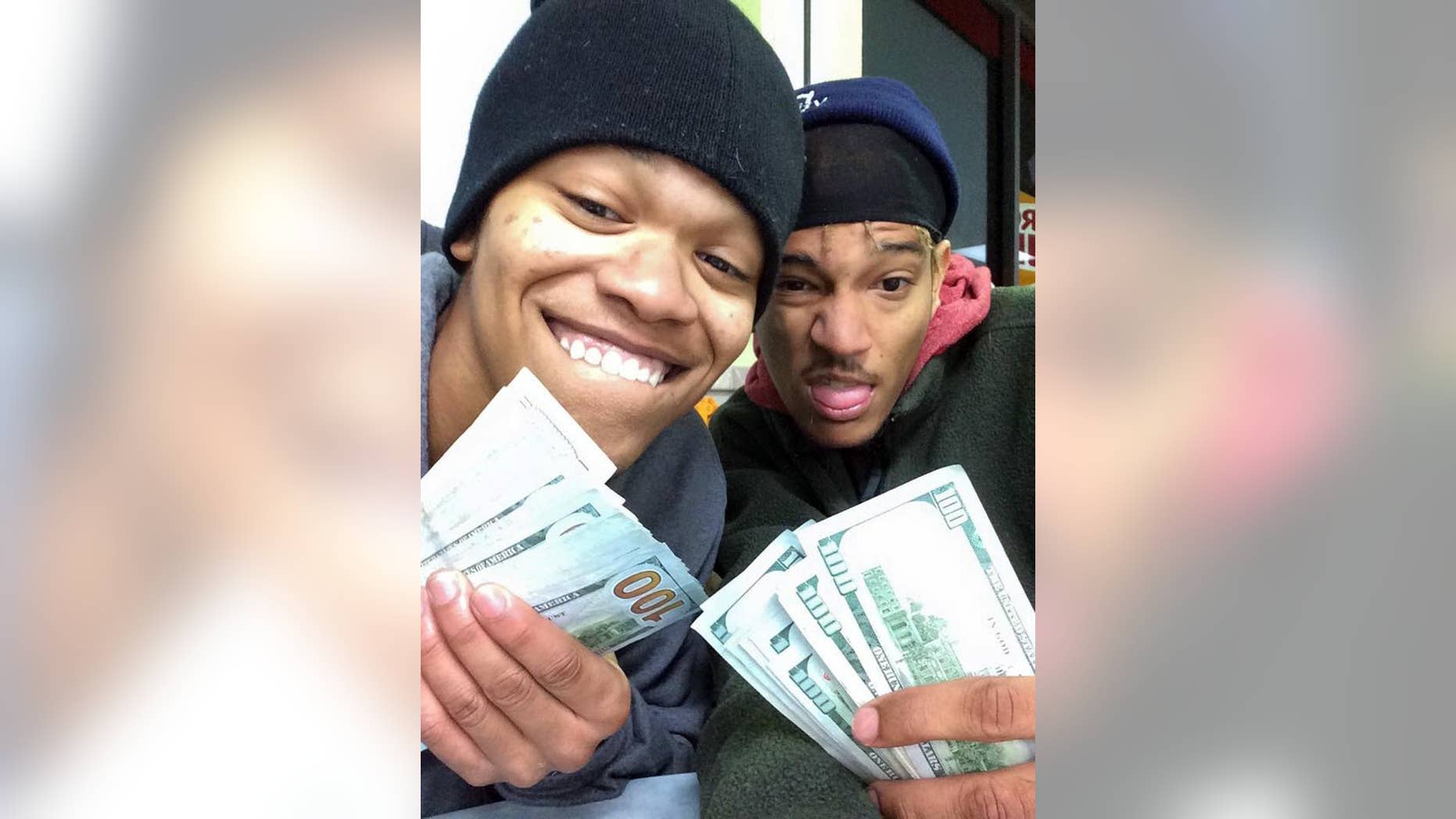 In this undated photo provided by Randy Schaefer, Dorian Walker-Gaines, left, and Dillan Thompson, pose for a selfie they unknowingly uploaded to Schaefer's iCloud account, made with Schaefer's stolen iPad holding money they allegedly took from his vehicle. Investigators arrested the pair on theft charges late Wednesday, Jan. 21, 2015, in Houston. The iPad, other electronics and thousands of dollars were stolen from the victim's truck Jan. 8. (AP Photo/Randy Schaefer)