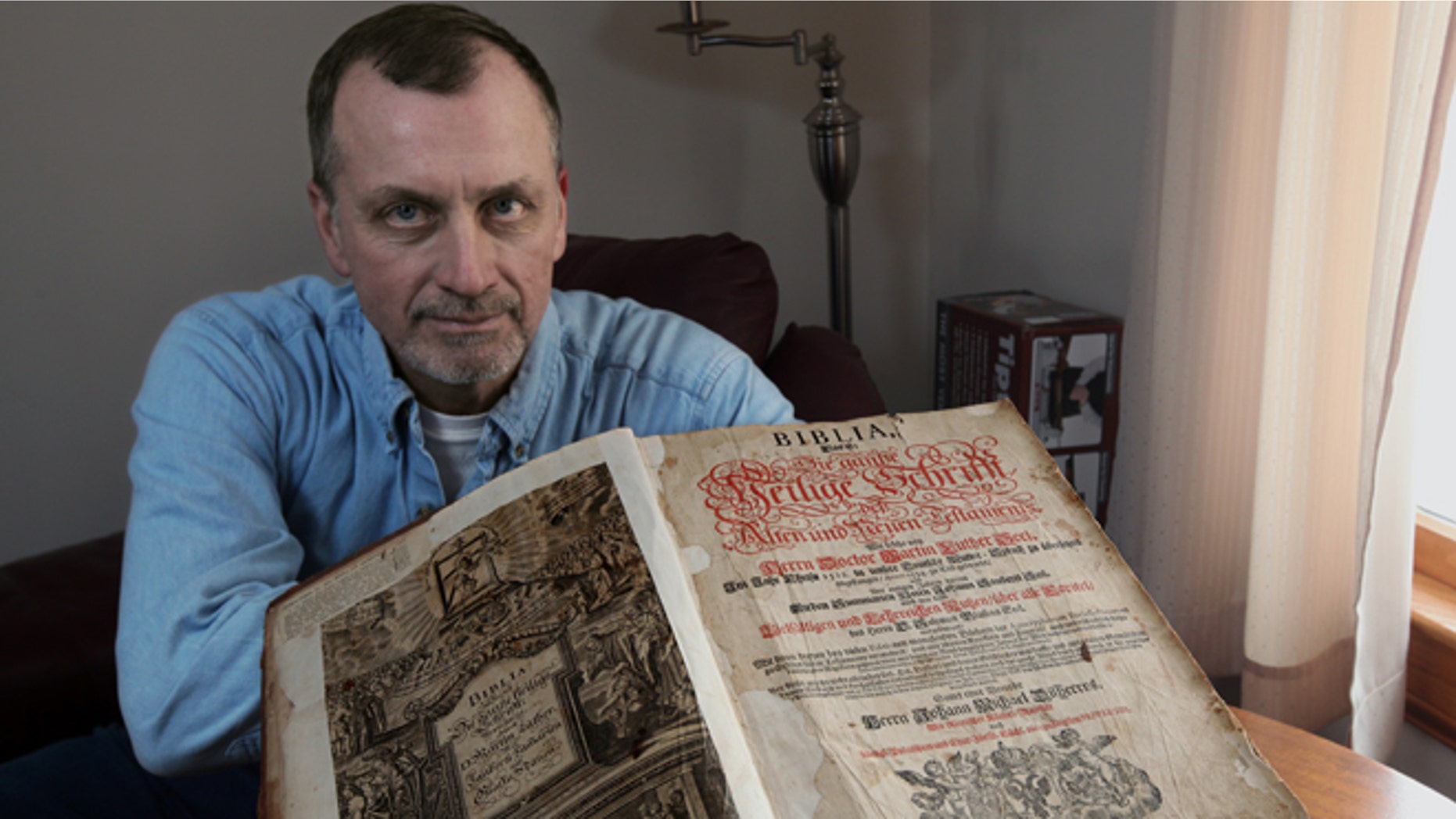 Feb. 3: Tim Shier holds up his family bible dating from the 1700s in his home in Marysville, Ohio.