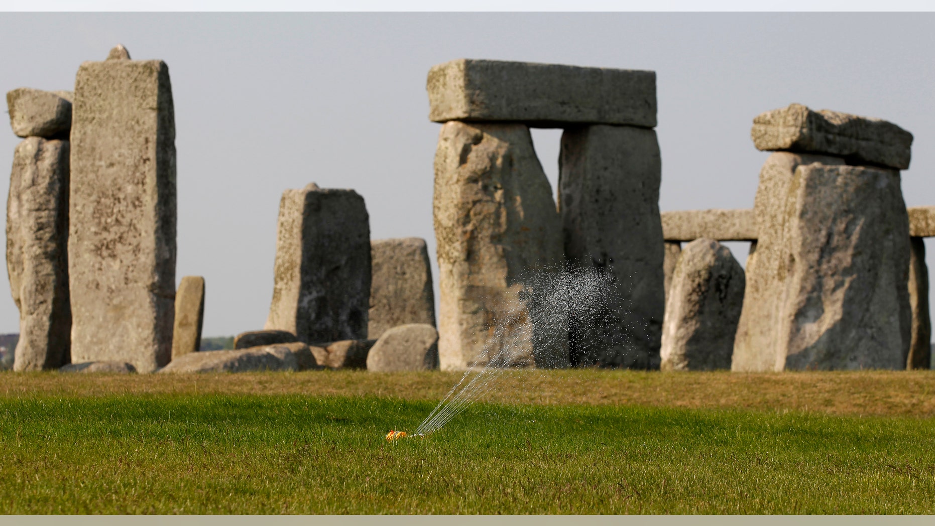 File photo - A sprinkler waters the grass surrounding the ancient site of Stonehenge, southern England April 30, 2011.