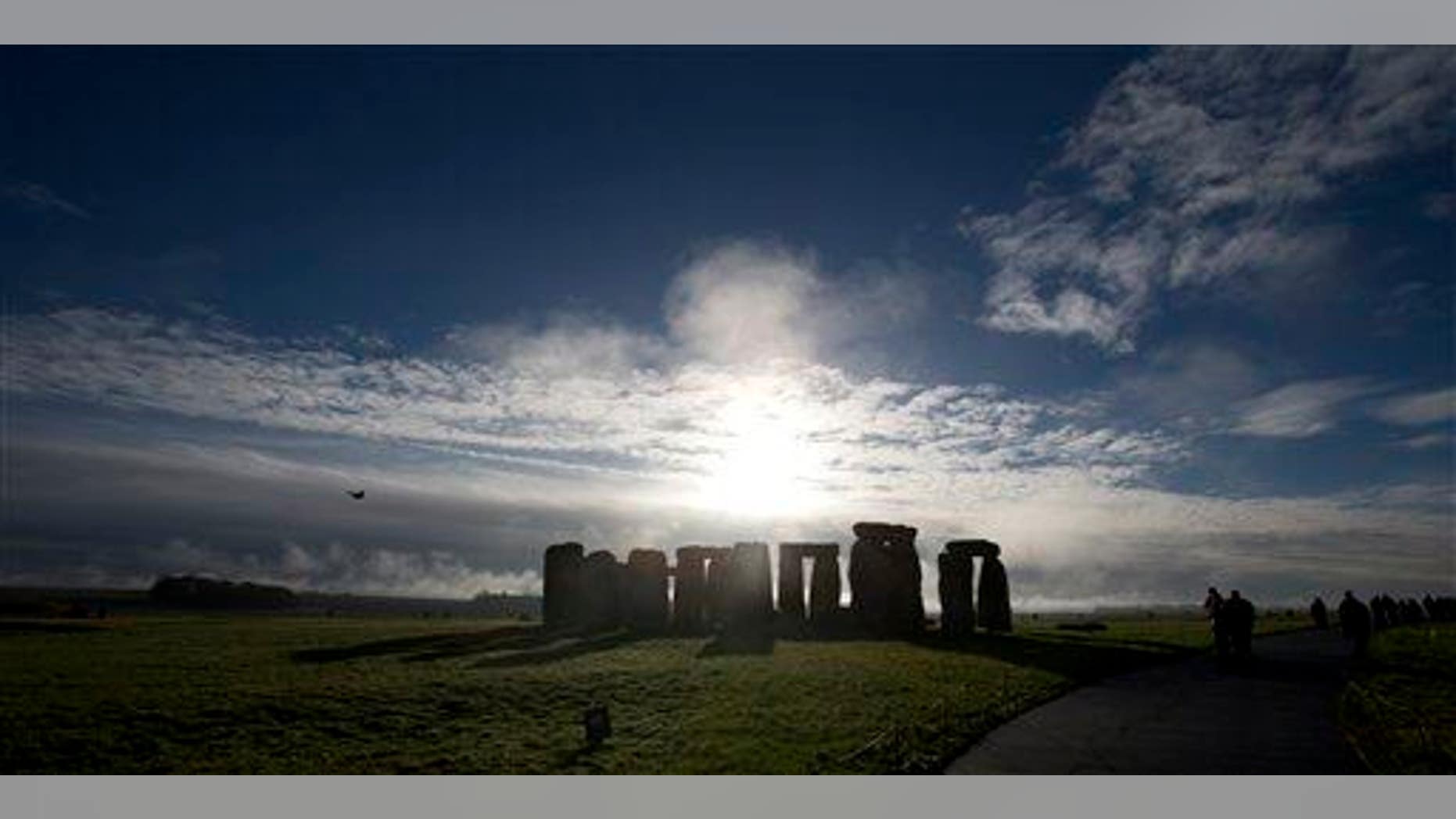 In this Tuesday Dec. 17, 2013 file photo, visitors take photographs of the world heritage site of Stonehenge, England.