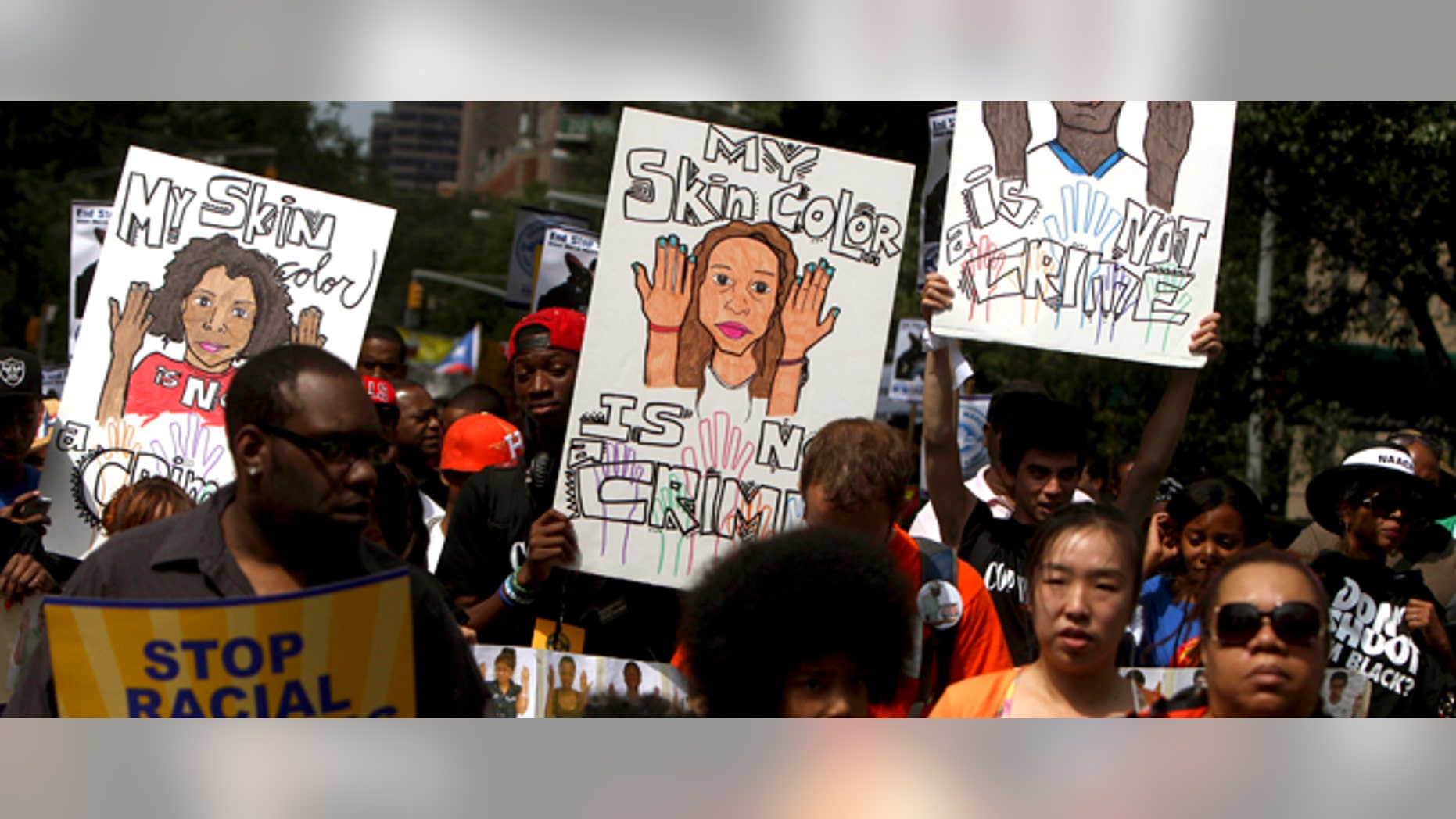 FILE - In this June 17, 2012 file photo, demonstrators hold signs during a silent march in New York to end the New York City Police Departmentâs "stop-and-frisk" program. A federal trial is scheduled to begin in New York on Monday, March 18, 2013, where the NYPDâs practice of stopping, questioning and frisking people on the street will face a sweeping legal challenge. The outcome could bring major changes to the nation's largest police force and could affect how other departments use the stop and frisk tactic. (AP Photo/Seth Wenig, File)