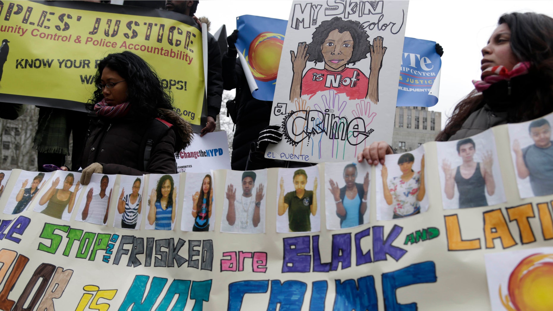 Protesters participate in a rally near the federal courthouse in New York, Monday, March 18, 2013. Many of the 5 million New Yorkers stopped, questioned and sometimes frisked by police in the past decade were wrongly targeted because of their race, lawyers for four men who said they were illegally stopped said Monday. (AP Photo/Seth Wenig)